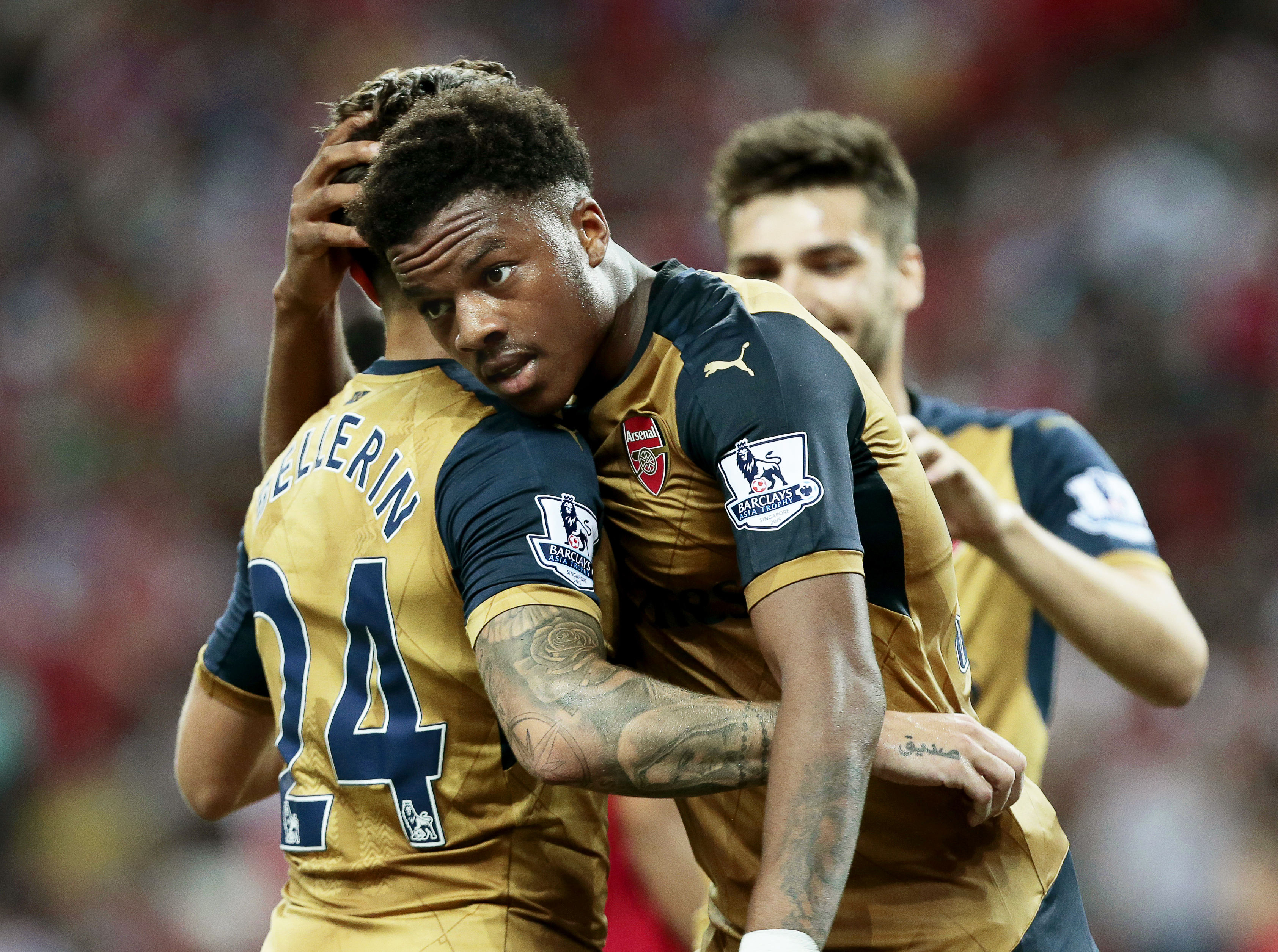 epa04847847 Arsenal forward Chuba Akpom (C) celebrates with his teammates Hector Bellerin (L) and Jon Toral (R) after scoring a hattrick during the Barclays Asia Trophy soccer match between Arsenal FC and a Singapore Selection at the National Stadium in Singapore, 15 July 2015. The Barclays Asia Trophy takes place on 15 and 18 July 2015 involving English Premier League teams Arsenal, Everton, and Stoke City and a Singapore Selection team. EPA/WALLACE WOON