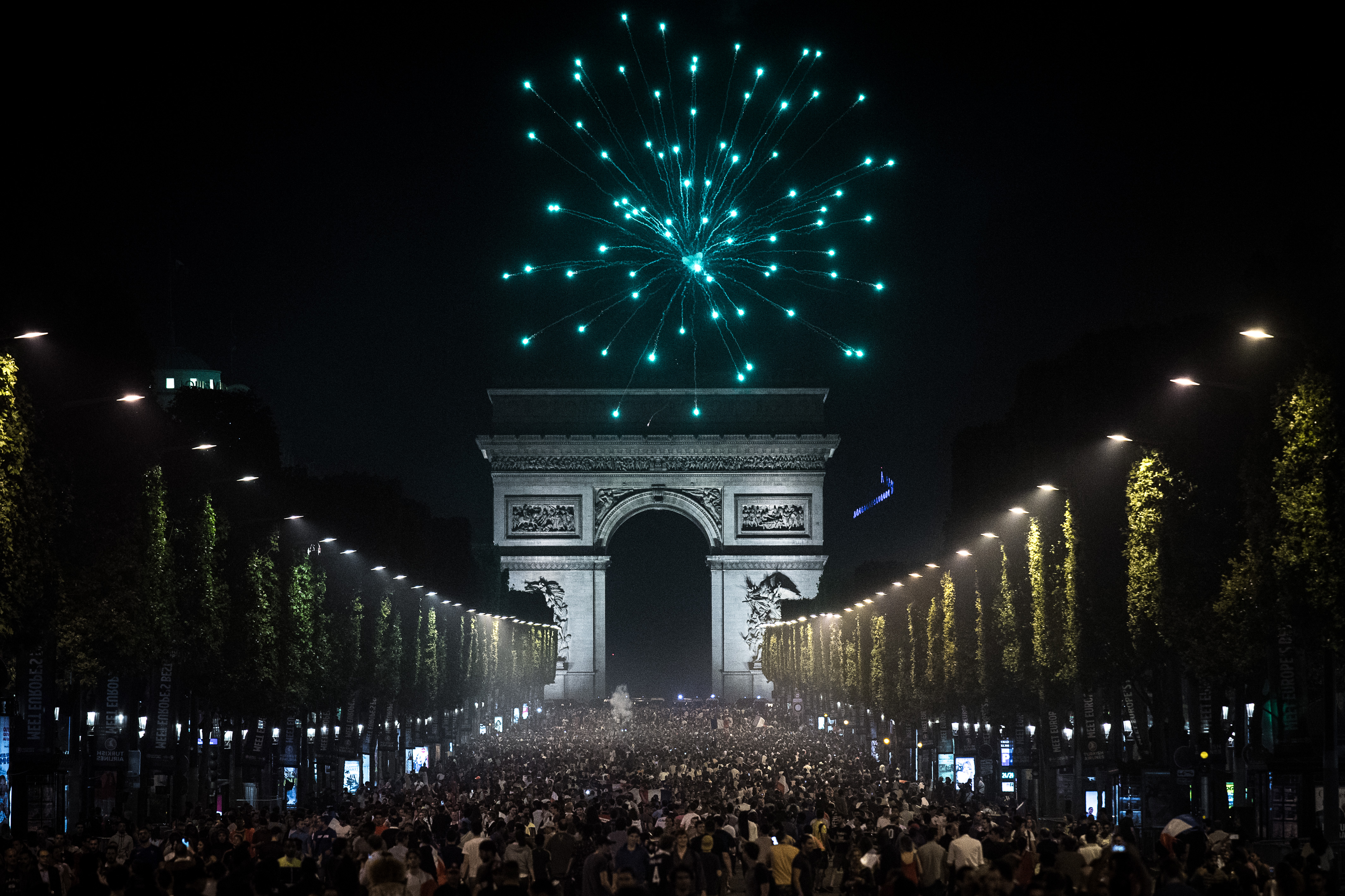 France supporters celebrate on the Champ Elysees after France won the Euro 2016 semi-final football match against Germany on the Champs Elysees in Paris, on July 7, 2016.  / AFP / PHILIPPE LOPEZ        (Photo credit should read PHILIPPE LOPEZ/AFP/Getty Images)