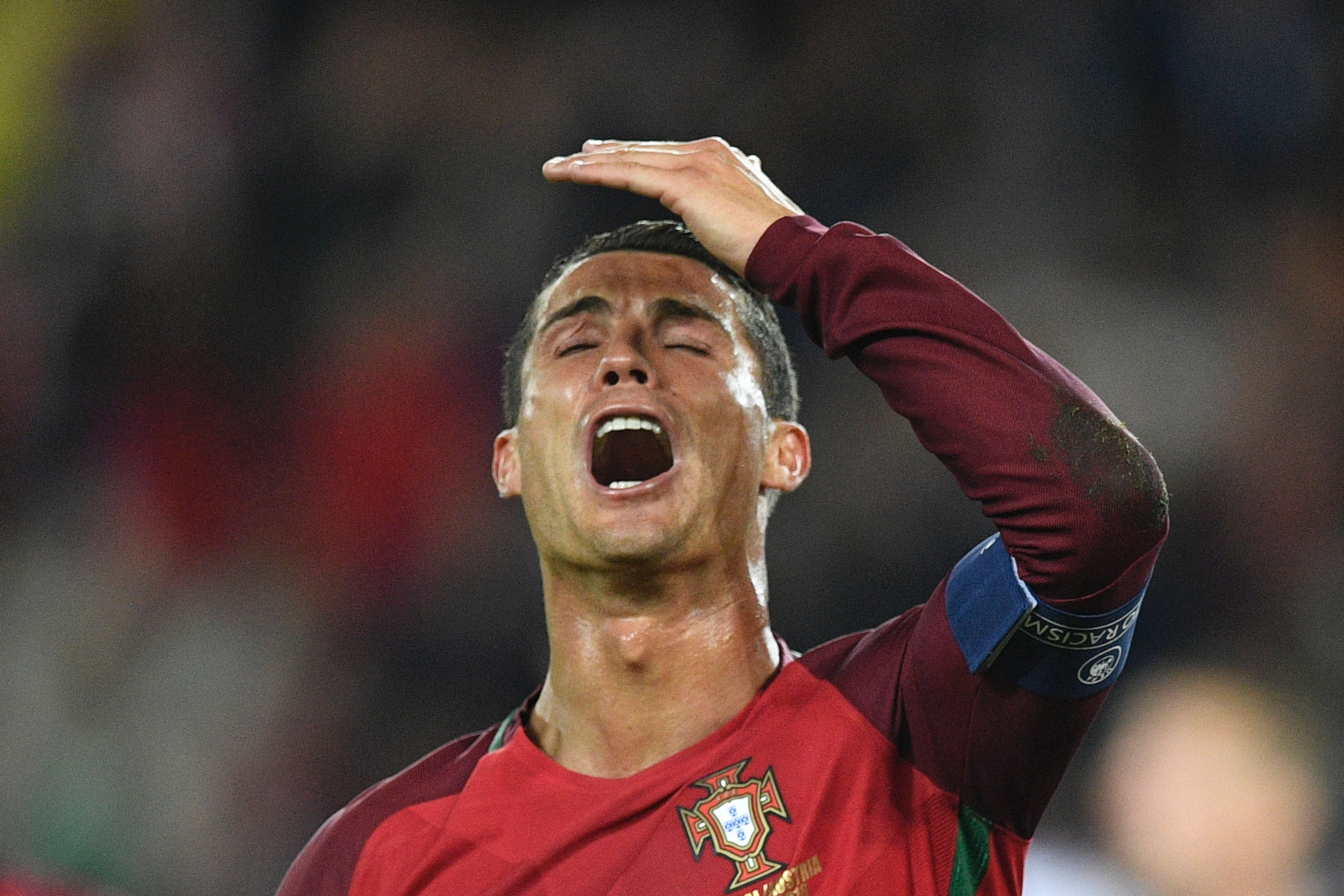 Portugal's forward Cristiano Ronaldo reacts after he missed to score a penalty during the Euro 2016 group F football match between Portugal and Austria at the Parc des Princes in Paris on June 18, 2016. / AFP / MARTIN BUREAU        (Photo credit should read MARTIN BUREAU/AFP/Getty Images)