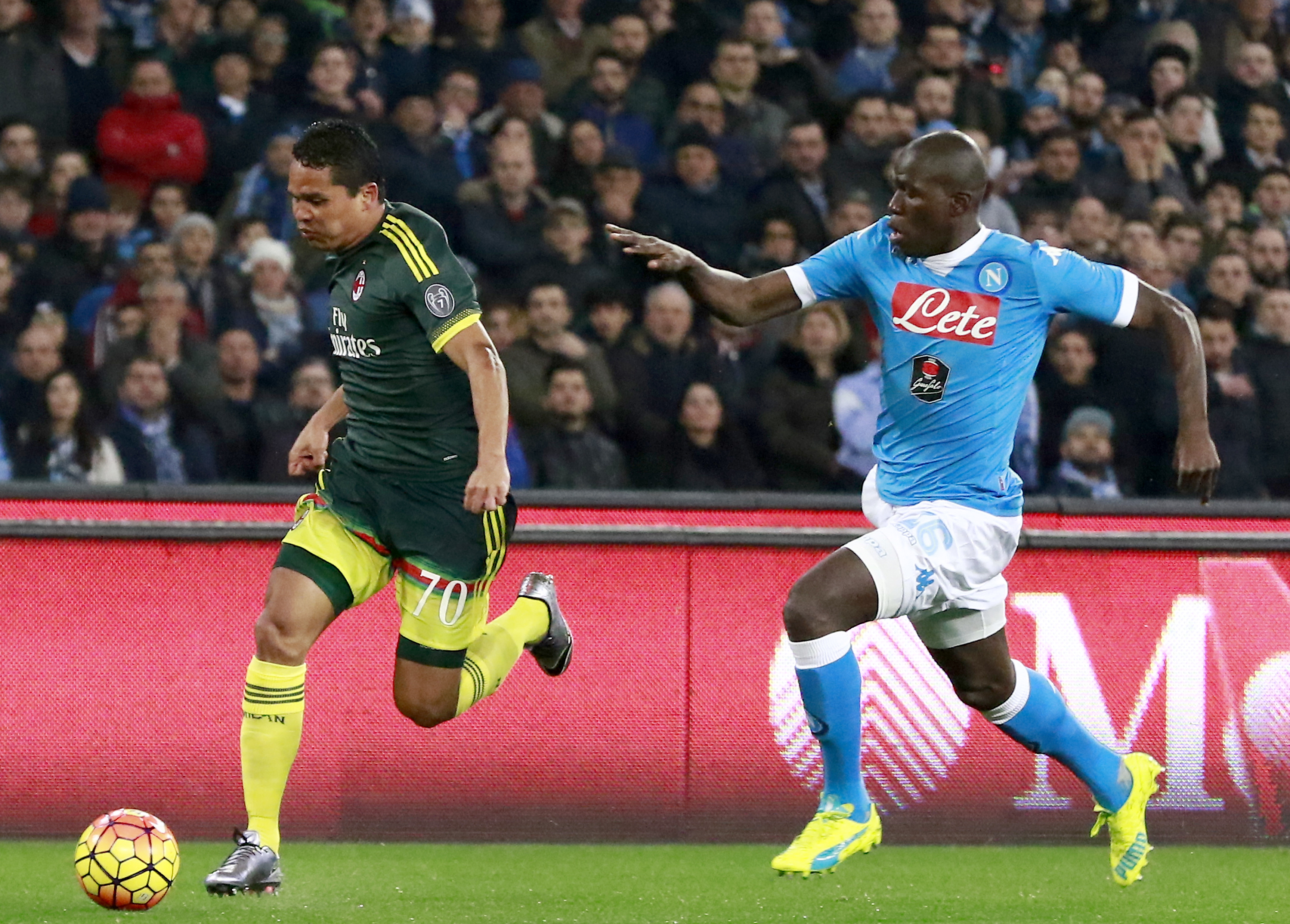 AC Milan's Colombian forward Carlos Bacca runs for the ball against Napoli's French defender Kalidou Koulibaly (R) during the Italian Serie A football match SSC Napoli vs AC Milan on February 22, 2016 at the San Paolo stadium in Naples. / AFP / CARLO HERMANN        (Photo credit should read CARLO HERMANN/AFP/Getty Images)