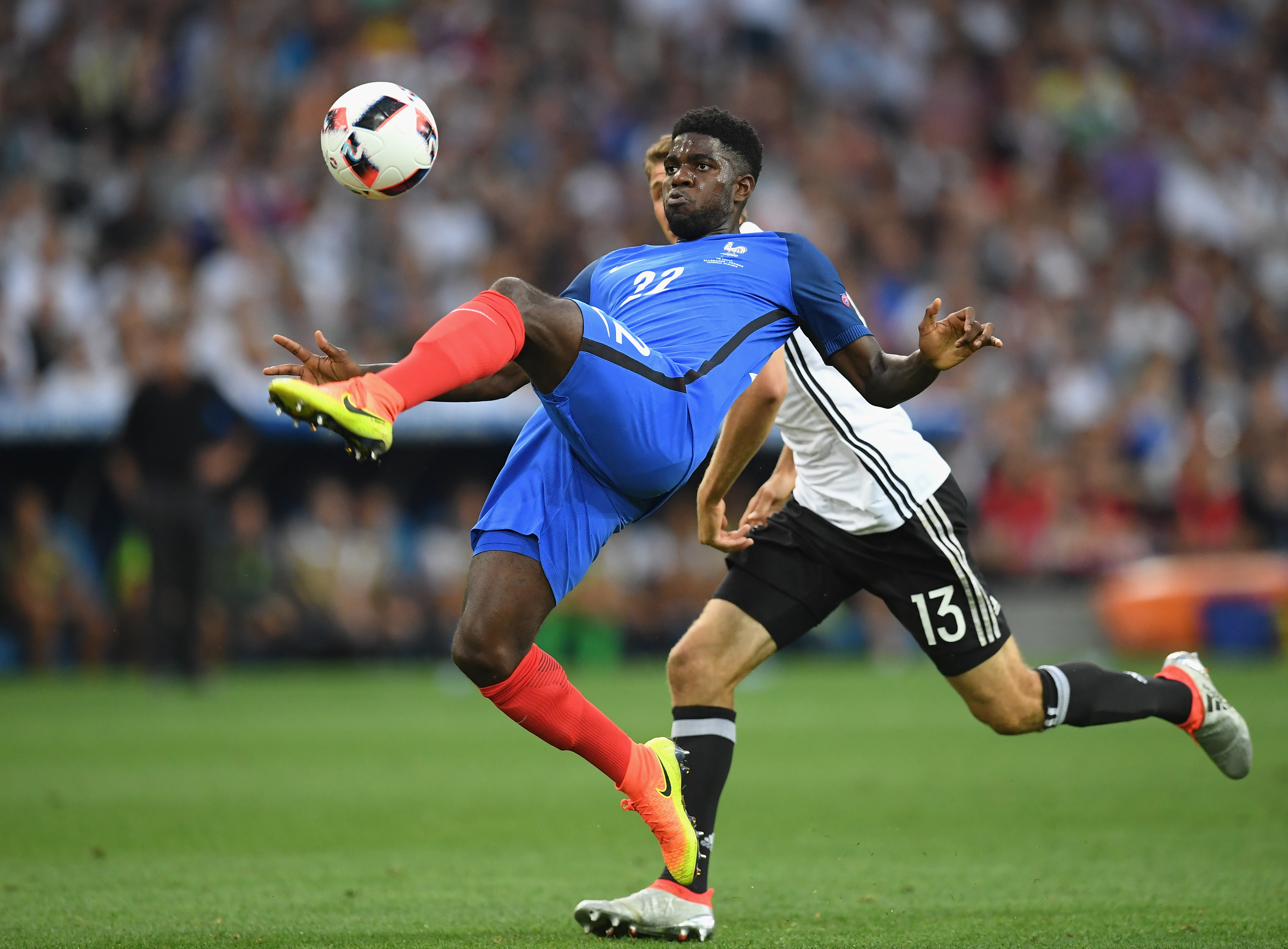 MARSEILLE, FRANCE - JULY 07: Samuel Umtiti of France clears the ball under pressure from Thomas Mueller of Germany during the UEFA EURO semi final match between Germany and France at Stade Velodrome on July 7, 2016 in Marseille, France. (Photo by Matthias Hangst/Getty Images)