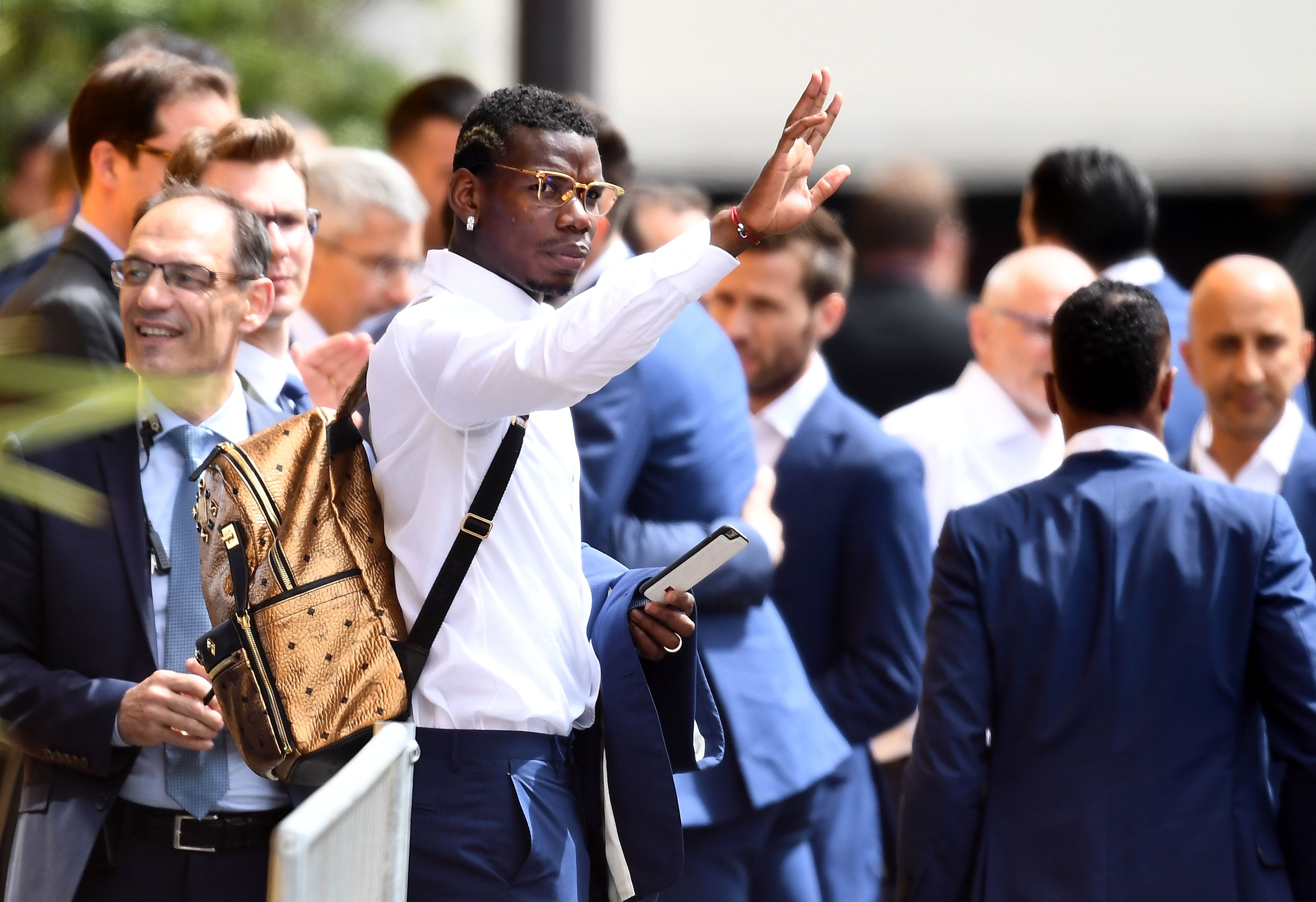 France's midfielder Paul Pogba waves at supporters as France's national football team players leave their hotel on their way to the Elysee Palace in Paris on July 11, 2016, a day after Portugal beat France in the Euro 2016 final football match. / AFP / FRANCK FIFE (Photo credit should read FRANCK FIFE/AFP/Getty Images)