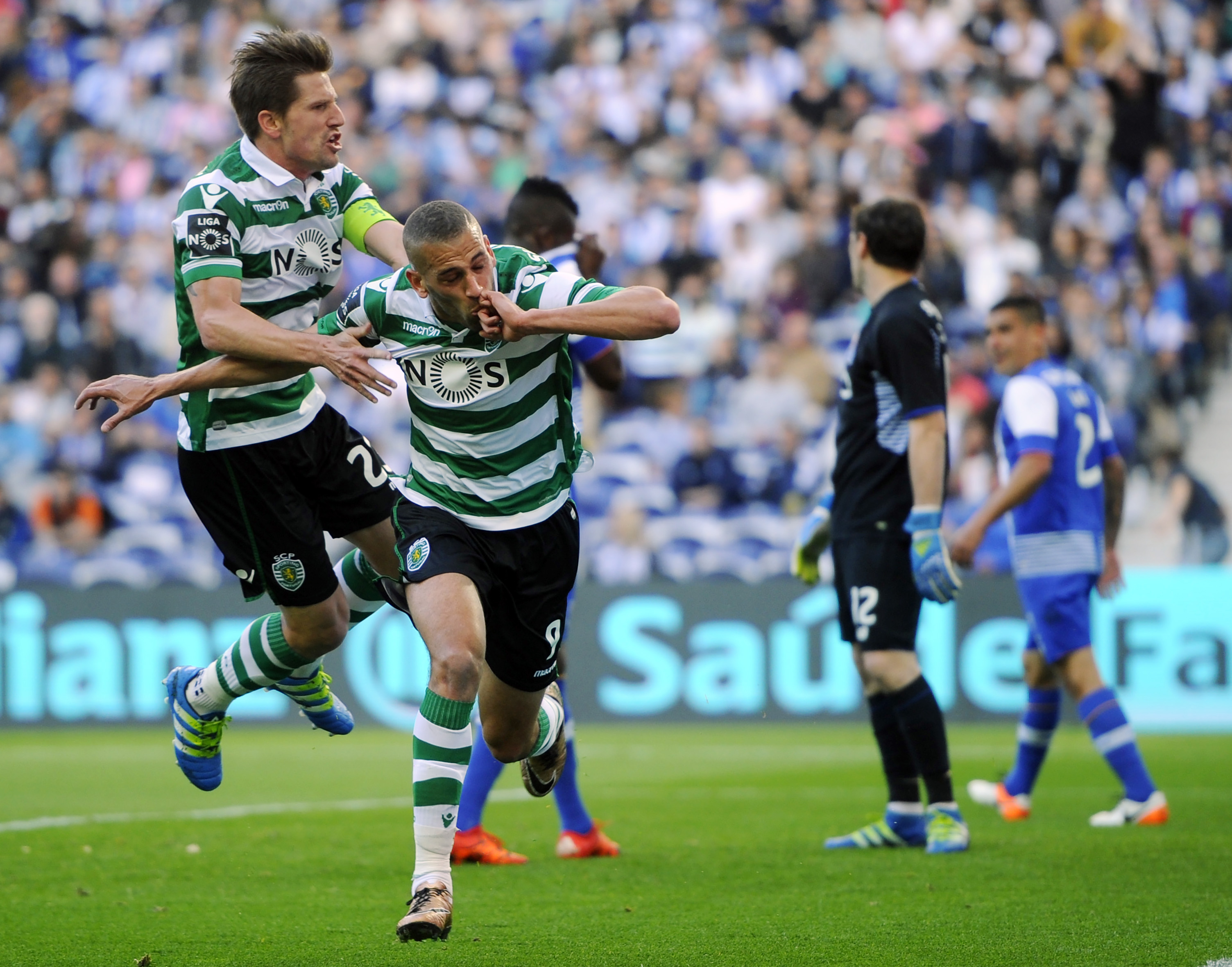 Sporting's Algerian forward Islam Slimani (2nd L) celebrates a goal with teammate midfielder Adrien Silva (L) during the Portuguese league football match FC Porto vs Sporting CP at the Dragao stadium in Porto on April 30, 2016. / AFP / MIGUEL RIOPA        (Photo credit should read MIGUEL RIOPA/AFP/Getty Images)