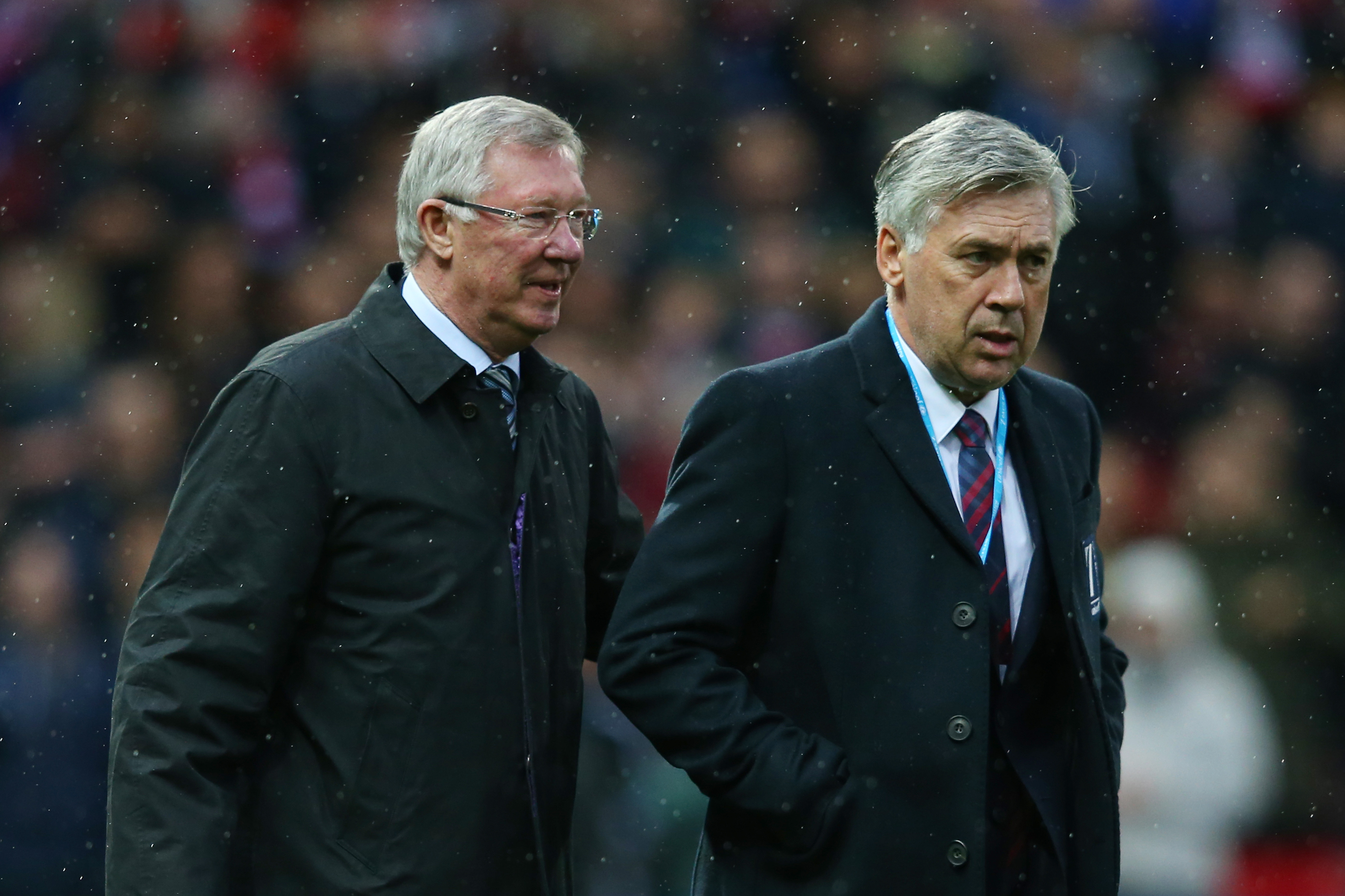 MANCHESTER, ENGLAND - NOVEMBER 14:  (L-R) Sir Alex Ferguson the manager of Great Britain and Ireland and Carlo Ancelotti the manager of the Rest of the World take their seats during the David Beckham Match for Children in aid of UNICEF between Great Britain & Ireland and Rest of the World at Old Trafford on November 14, 2015 in Manchester, England.  (Photo by Alex Livesey/Getty Images)