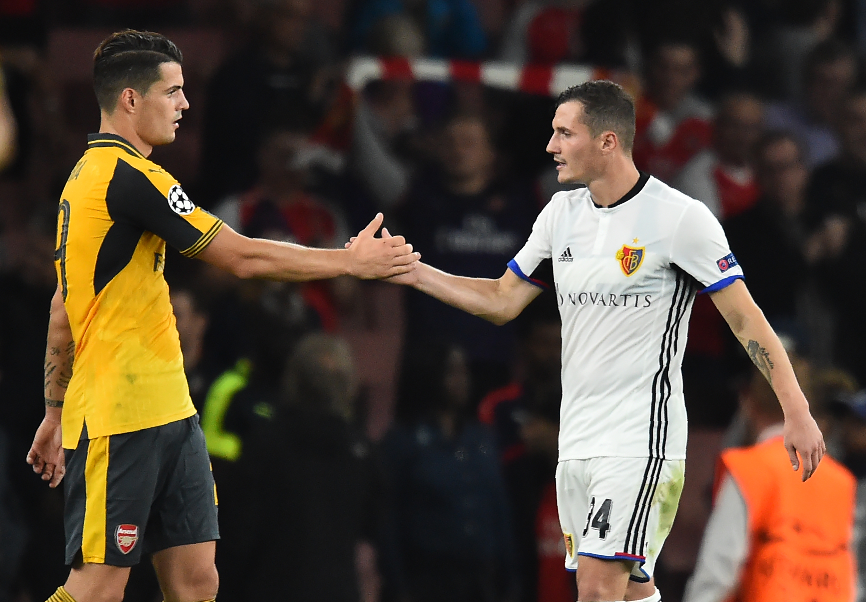 Arsenal's Swiss midfielder Granit Xhaka (L) shakes hands with his brother Basel's Albanian midfielder Taulant Xhaka after the UEFA Champions League Group A football match between Arsenal and FC Basel at The Emirates Stadium in London on September 28, 2016.
Arsenal won the game 2-0. / AFP / IKIMAGES / Glyn KIRK (Photo credit should read GLYN KIRK/AFP/Getty Images)