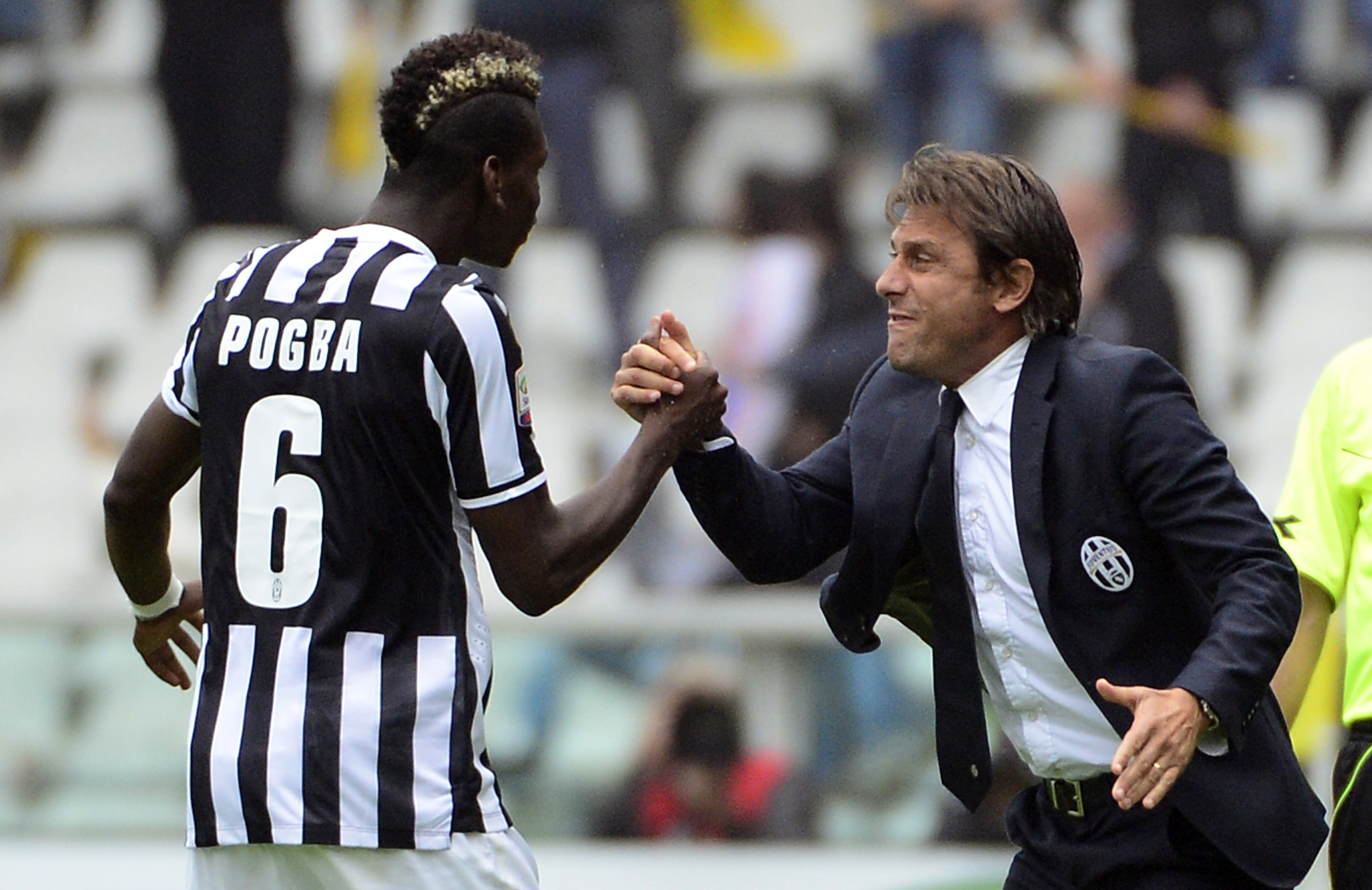 Juventus' French midfielder Paul Labile Pogba (L) celebrates with coach Antonio Conte after scoring during the Serie A football match Torino vs Juventus at the Olimpico stadium on September 29, 2013 in Turin. AFP PHOTO / OLIVIER MORIN        (Photo credit should read OLIVIER MORIN/AFP/Getty Images)