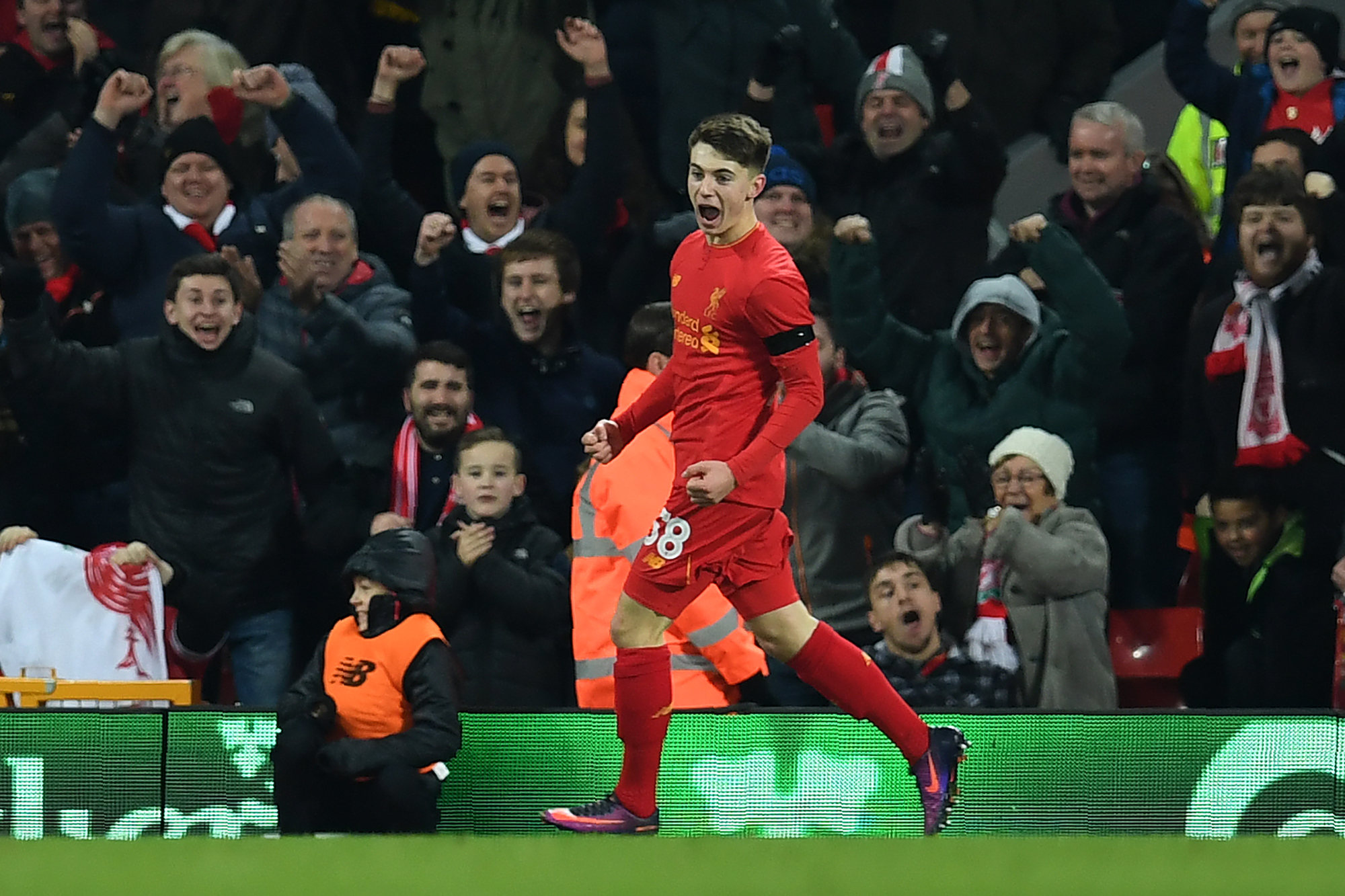 Liverpool's Welsh striker Ben Woodburn celebrates scoring his team's second goal during the EFL (English Football League) Cup quarter-final football match between Liverpool and Leeds United at Anfield in Liverpool, north west England on November 29, 2016.
Liverpool won the match 2-0. / AFP / Paul ELLIS / RESTRICTED TO EDITORIAL USE. No use with unauthorized audio, video, data, fixture lists, club/league logos or 'live' services. Online in-match use limited to 75 images, no video emulation. No use in betting, games or single club/league/player publications.  /         (Photo credit should read PAUL ELLIS/AFP/Getty Images)