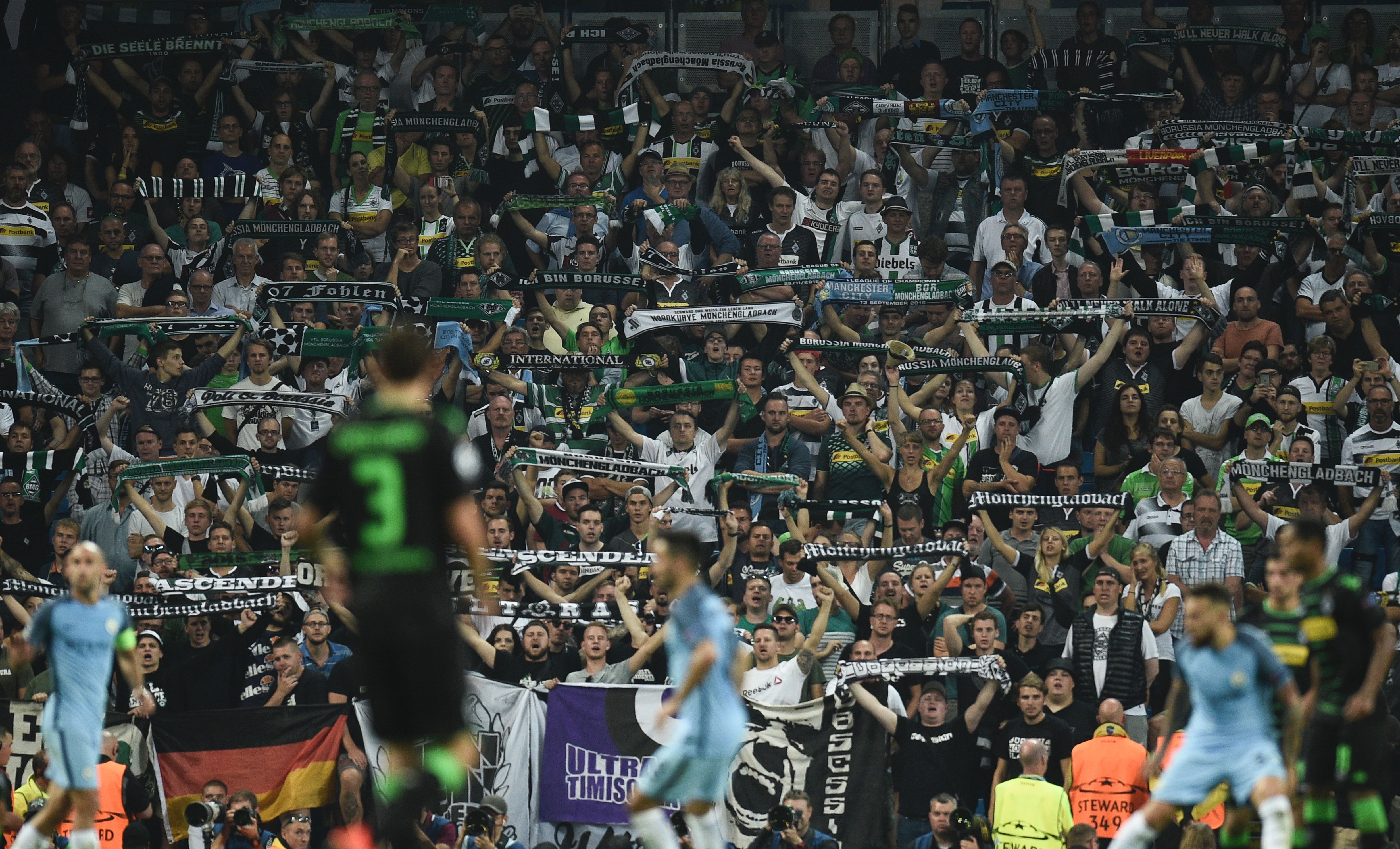 Monchengladbach fans hold up scarves during the UEFA Champions League group C football match between Manchester City and Borussia Monchengladbach at the Etihad stadium in Manchester, northwest England, on September 14, 2016. (Photo by Oli Scarff/AFP/Getty Images)
