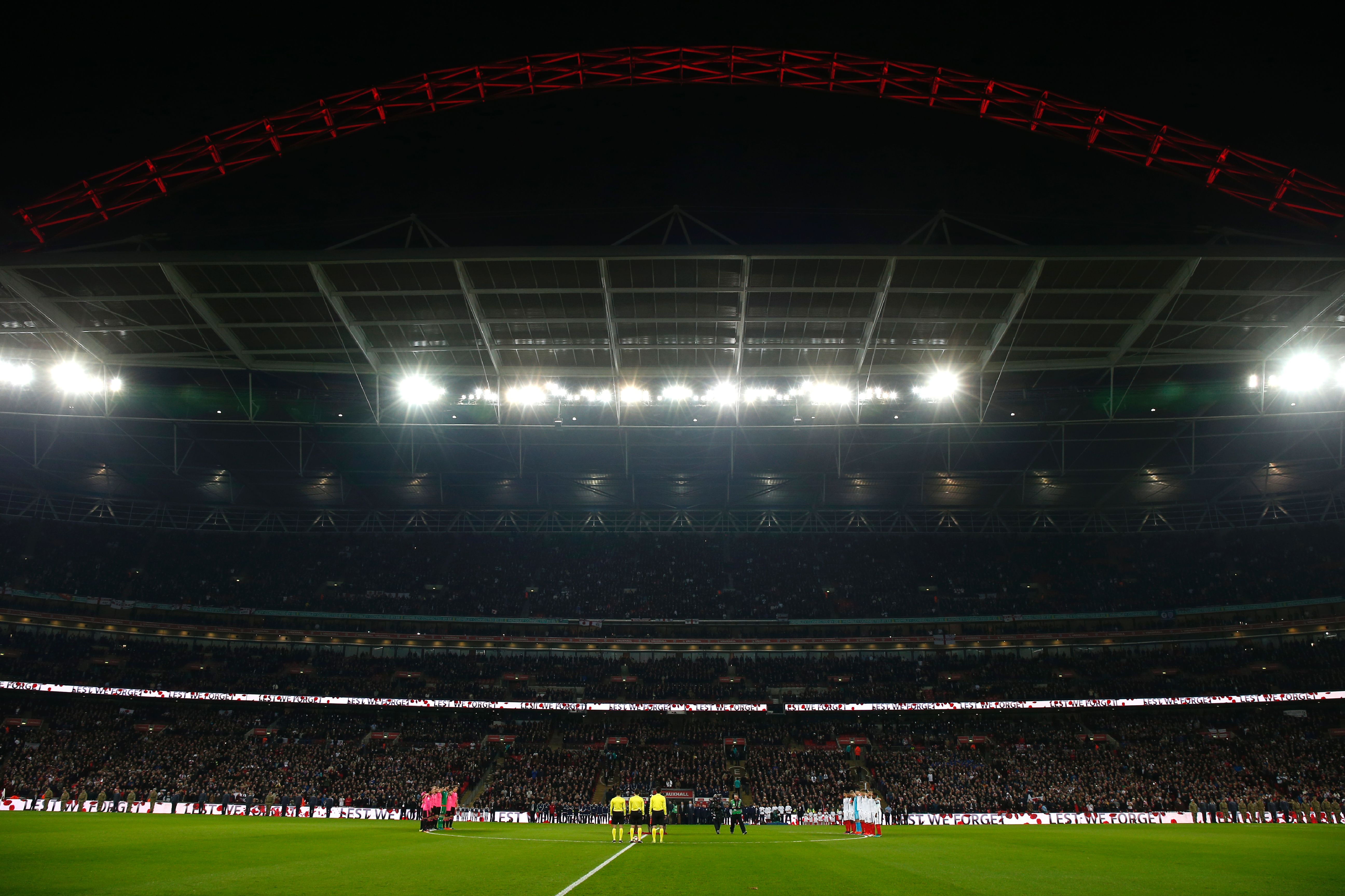 The teams of Scotland and England stand for a minutes silence to honour the war dead before a World Cup 2018 qualification match between England and Scotland at Wembley stadium in London on November 11, 2016. / AFP / Ian Kington / NOT FOR MARKETING OR ADVERTISING USE / RESTRICTED TO EDITORIAL USE
        (Photo credit should read IAN KINGTON/AFP/Getty Images)