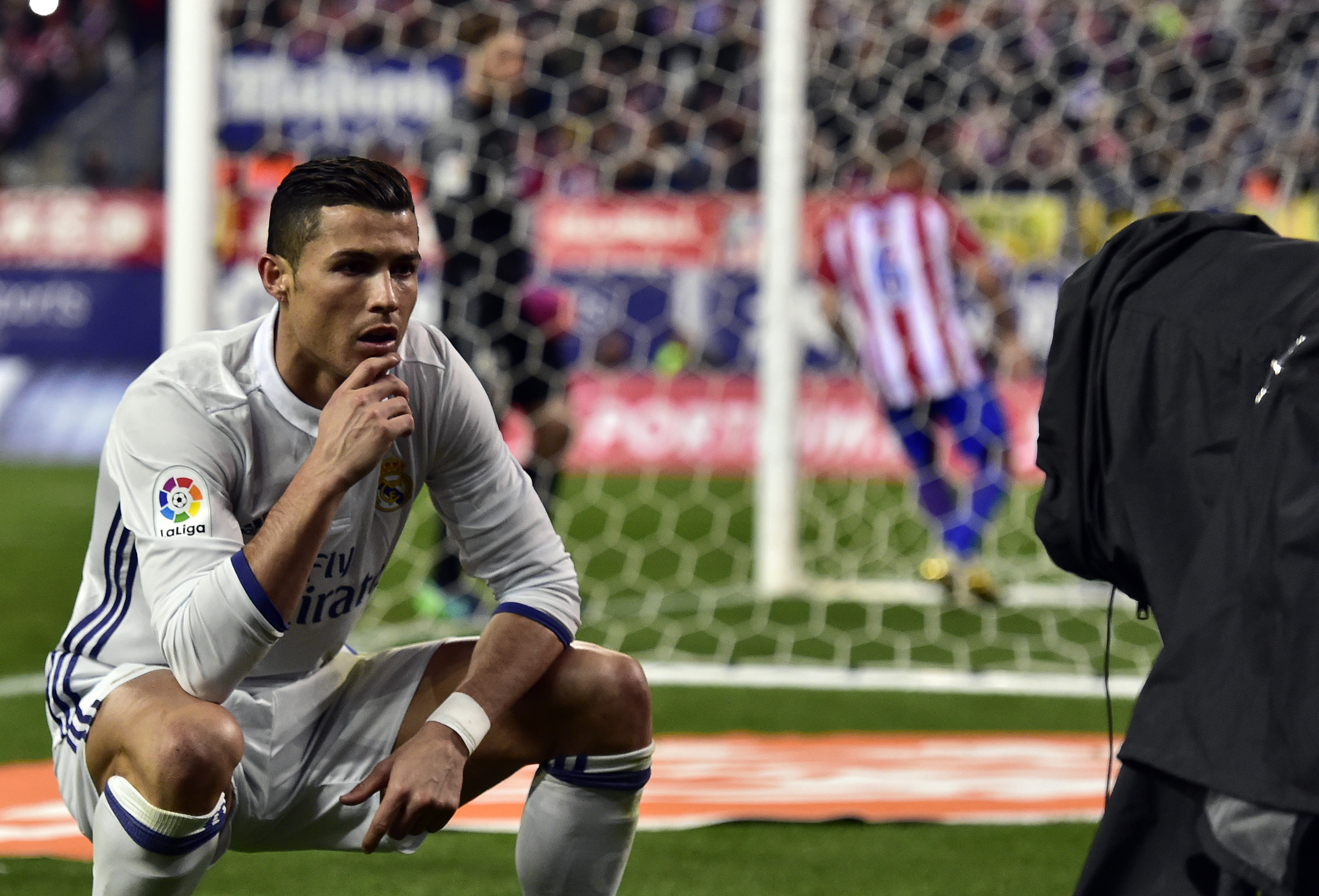 TOPSHOT - Real Madrid's Portuguese forward Cristiano Ronaldo poses in front of a TV camera as he celebrates after scoring during the Spanish league football match Club Atletico de Madrid vs Real Madrid CF at the Vicente Calderon stadium in Madrid, on November 19, 2016.
Real Madrid won 3-0. / AFP / GERARD JULIEN        (Photo credit should read GERARD JULIEN/AFP/Getty Images)