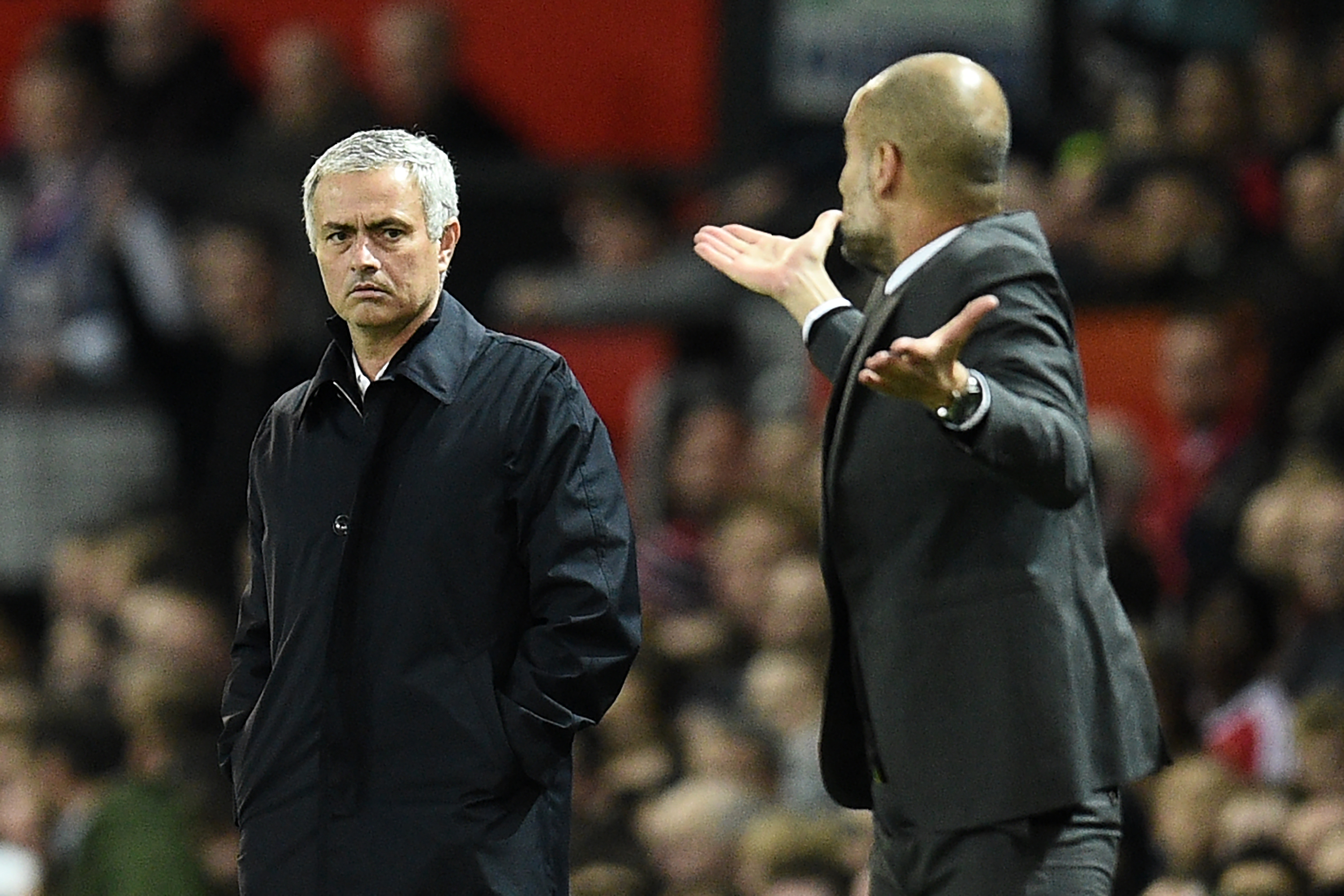 Manchester United's Portuguese manager Jose Mourinho (L) watches as Manchester City's Spanish manager Pep Guardiola gestures on the touchline during the EFL (English Football League) Cup fourth round match between Manchester United and Manchester City at Old Trafford in Manchester, north west England on October 26, 2016.         (Photo by Oli Scarff/AFP/Getty Images)