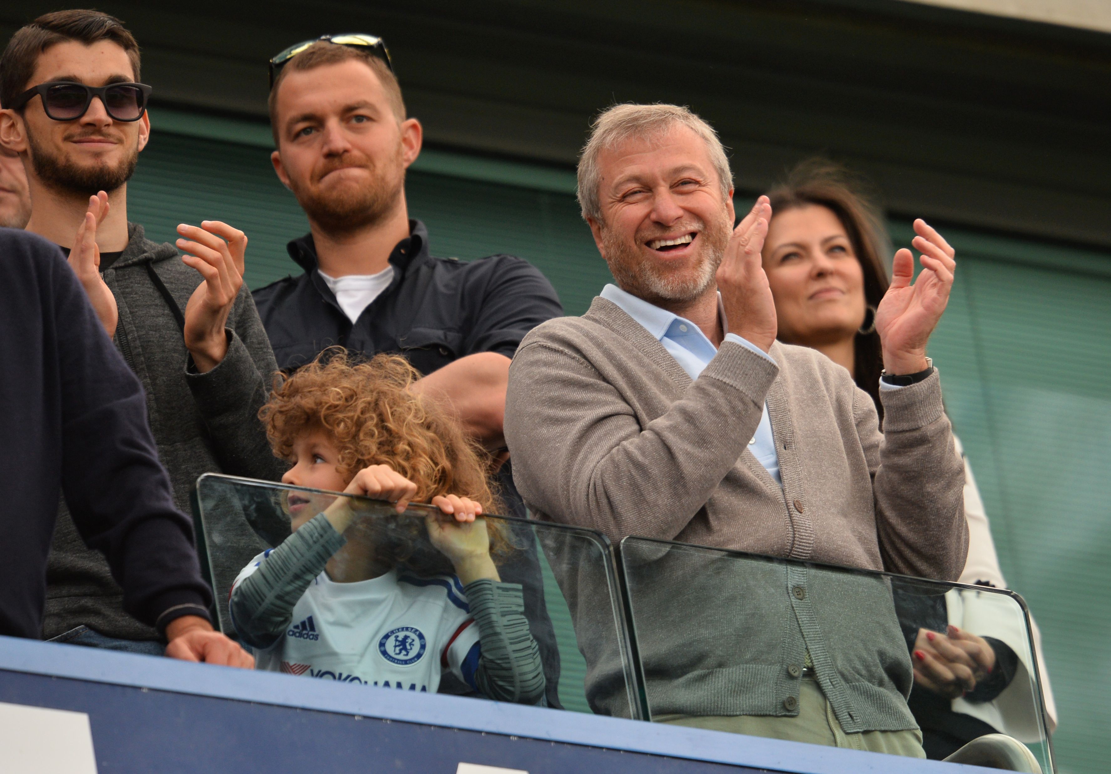 Chelsea's Russian owner Roman Abramovich (2R) smiles and applauds after the English Premier League football match between Chelsea and Leicester City at Stamford Bridge in London on May 15, 2016. / AFP / GLYN KIRK / RESTRICTED TO EDITORIAL USE. No use with unauthorized audio, video, data, fixture lists, club/league logos or 'live' services. Online in-match use limited to 75 images, no video emulation. No use in betting, games or single club/league/player publications.  /         (Photo credit should read GLYN KIRK/AFP/Getty Images)