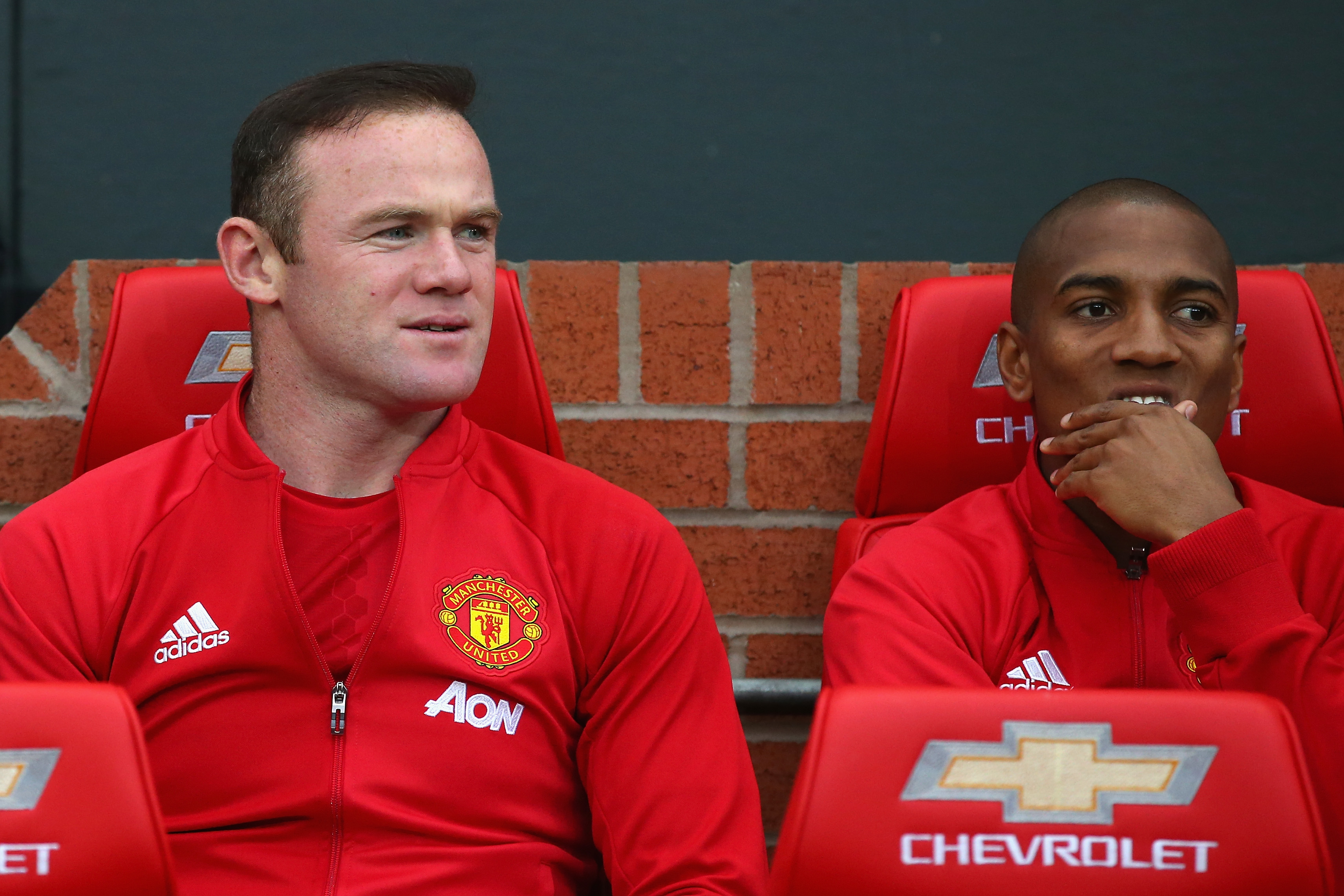 MANCHESTER, ENGLAND - OCTOBER 29: Wayne Rooney of Manchester United (L) takes his place on the bench with Ashley Young of Manchester United (R) during the Premier League match between Manchester United and Burnley at Old Trafford on October 29, 2016 in Manchester, England. (Photo by Alex Livesey/Getty Images)