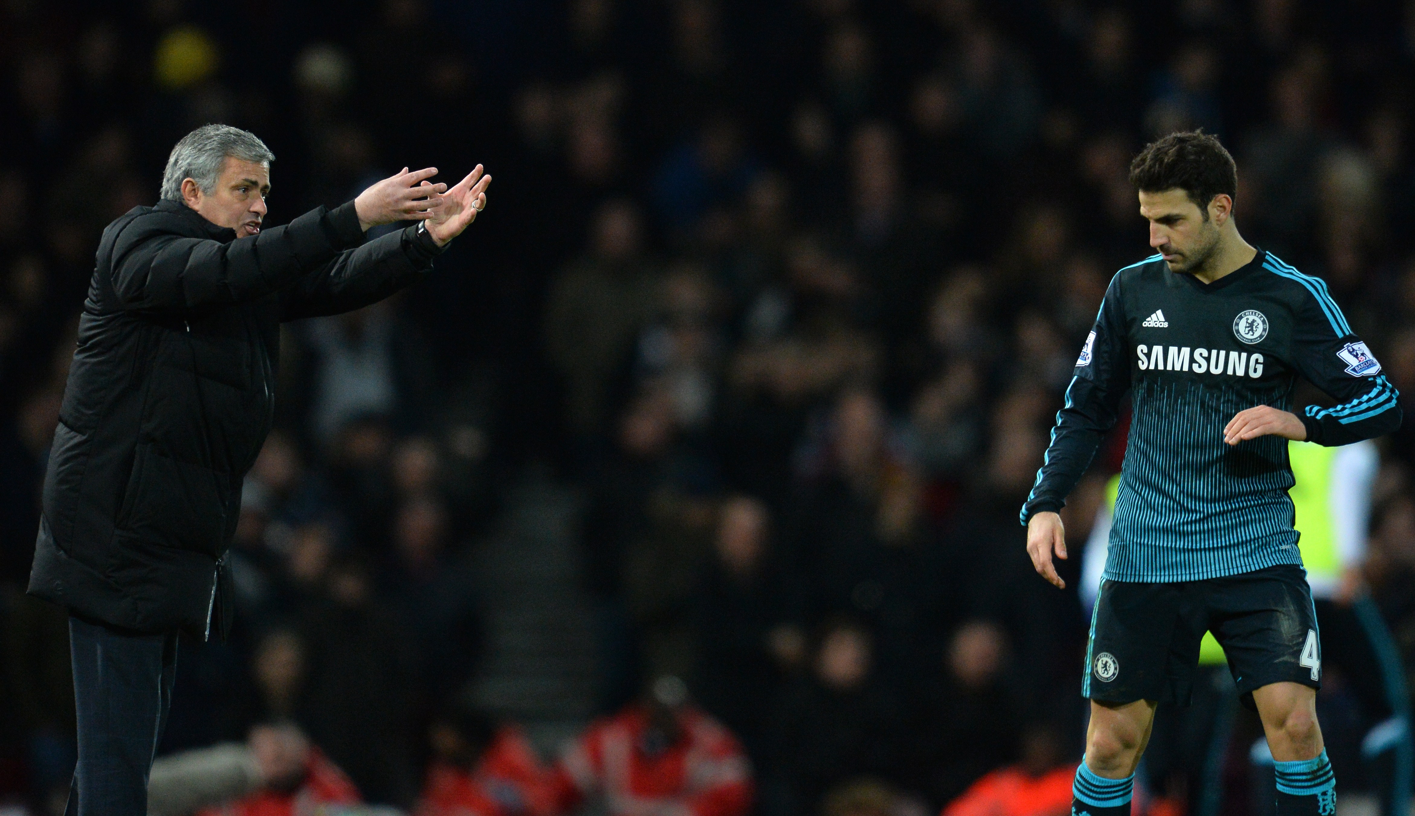 Chelsea's Portuguese manager Jose Mourinho gestures to Chelsea's Spanish midfielder Cesc Fabregas (R) during the English Premier League football match between West Ham United and Chelsea at the Boleyn Ground in Upton Park, East London on March 4, 2015. Chelsea won the game 1-0. AFP PHOTO / GLYN KIRK
RESTRICTED TO EDITORIAL USE. NO USE WITH UNAUTHORIZED AUDIO, VIDEO, DATA, FIXTURE LISTS, CLUB/LEAGUE LOGOS OR "LIVE" SERVICES. ONLINE IN-MATCH USE LIMITED TO 45 IMAGES, NO VIDEO EMULATION. NO USE IN BETTING, GAMES OR SINGLE CLUB/LEAGUE/PLAYER PUBLICATIONS. (Photo credit should read GLYN KIRK/AFP/Getty Images)