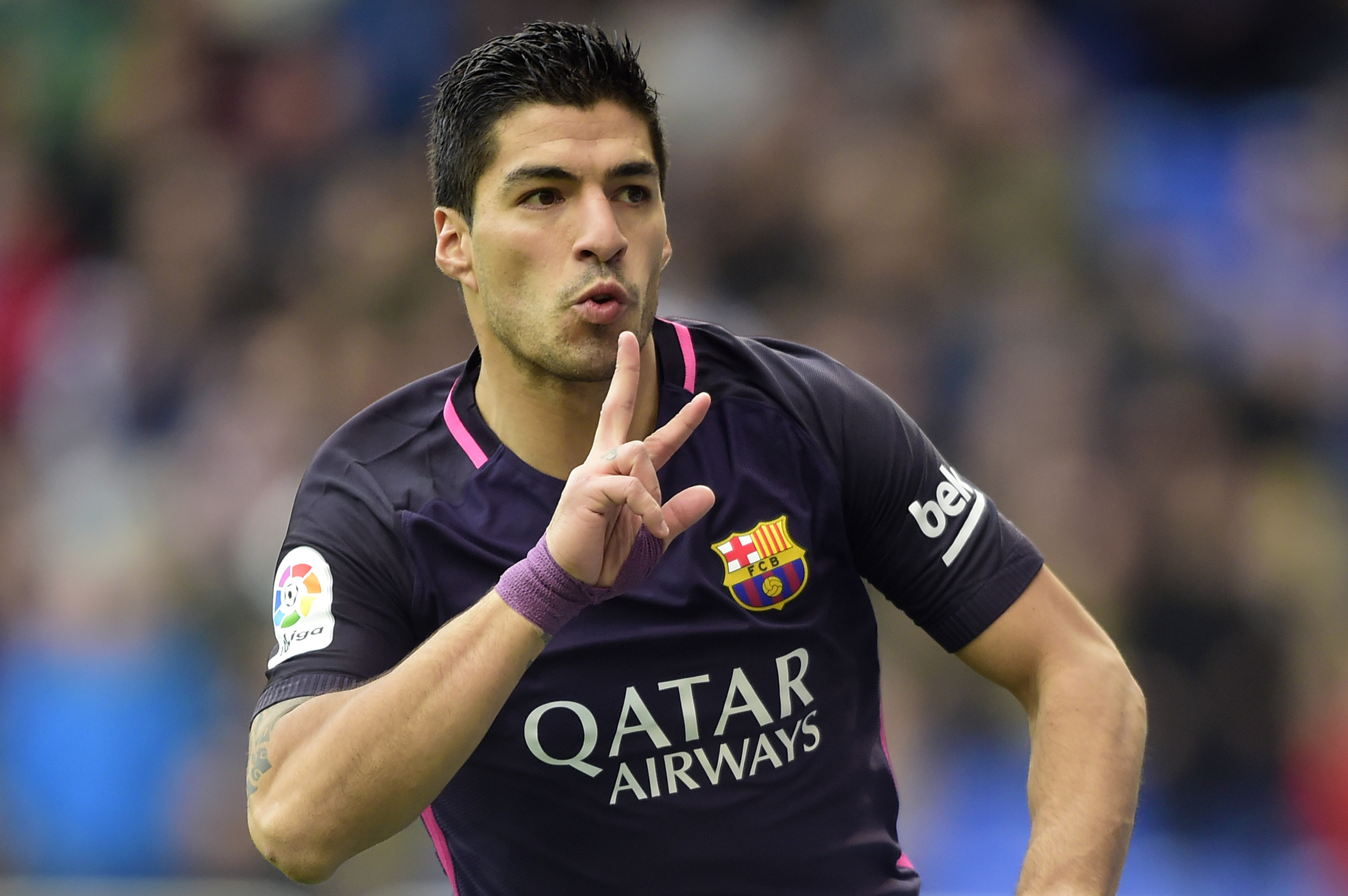Barcelona's Uruguayan forward Luis Suarez celebrates after scoring during the Spanish league football match RC Deportivo de la Coruna vs FC Barcelona at the Municipal de Riazor stadium in La Coruna on March 12, 2017. / AFP PHOTO / MIGUEL RIOPA (Photo credit should read MIGUEL RIOPA/AFP/Getty Images)