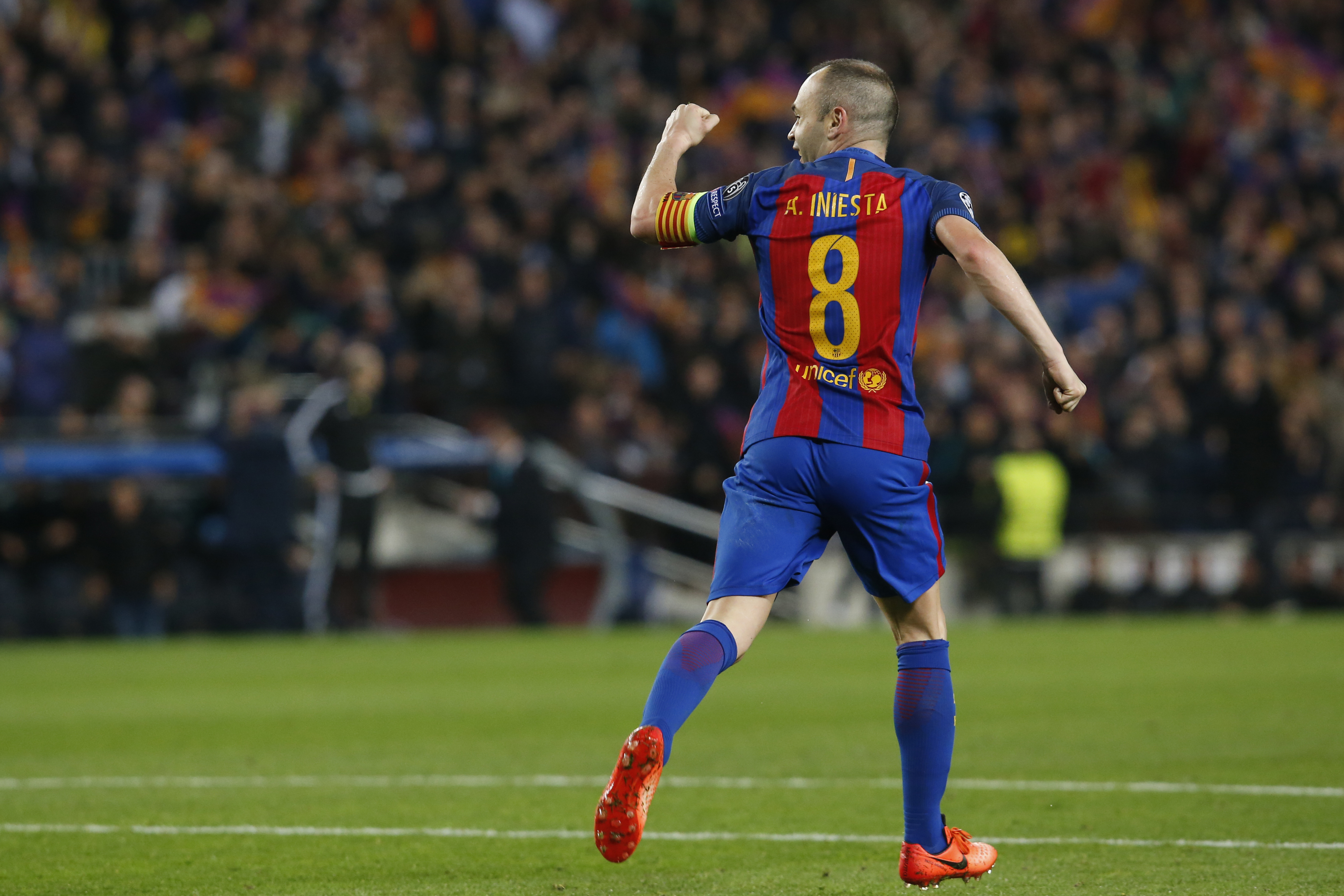 Barcelona's midfielder Andres Iniesta celebrates Paris Saint-Germain's own goal during the UEFA Champions League round of 16 second leg football match FC Barcelona vs Paris Saint-Germain FC at the Camp Nou stadium in Barcelona on March 8, 2017. / AFP PHOTO / PAU BARRENA (Photo credit should read PAU BARRENA/AFP/Getty Images)
