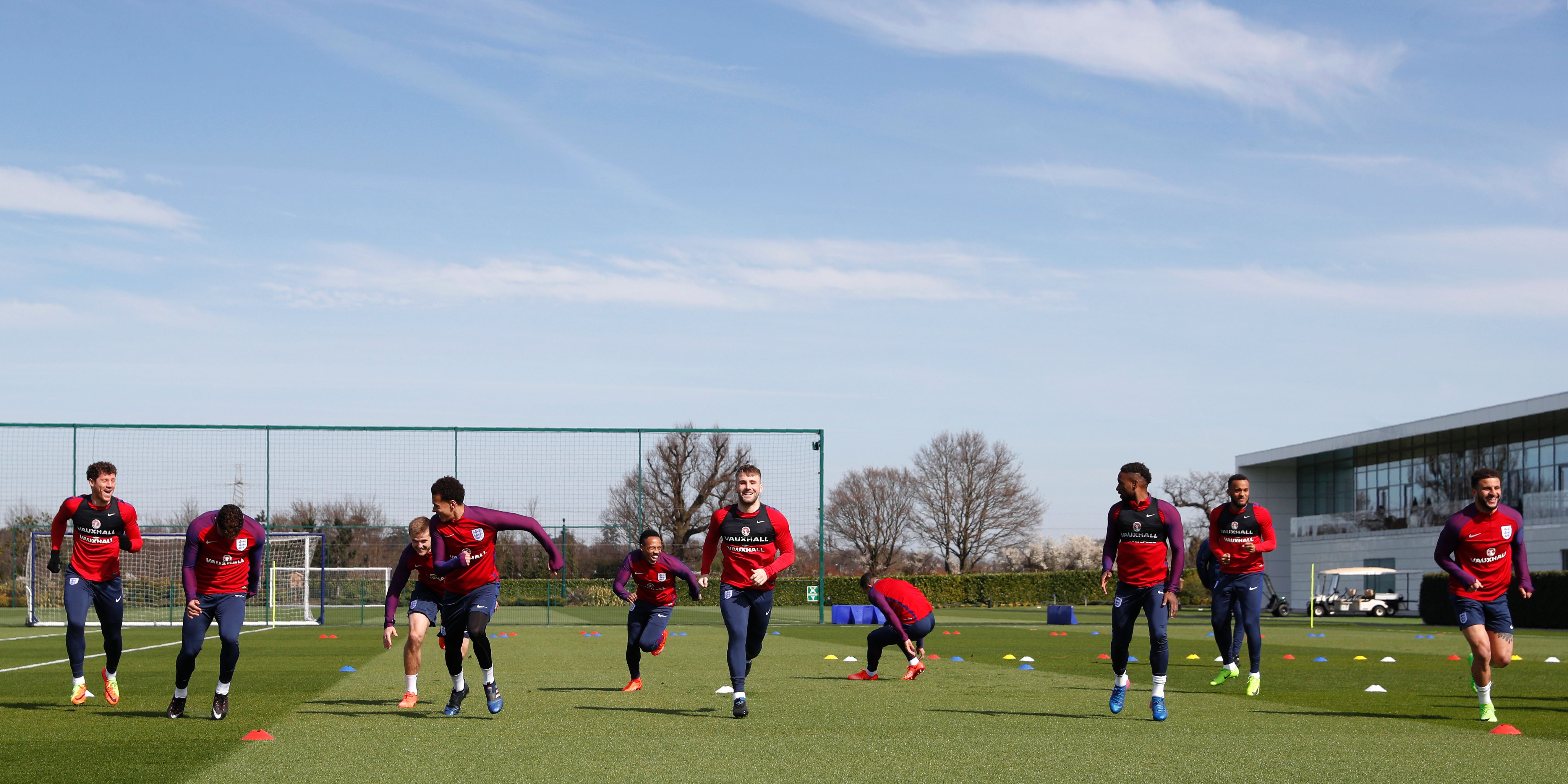 England players including defender Luke Shaw (C) chase each other during a training exercise at Tottenham Hotspur's training complex in Enfield, north London, on March 25, 2017 ahead of England's FIFA World Cup 2018 qualifier football match against Lithuania. / AFP PHOTO / ADRIAN DENNIS        (Photo credit should read ADRIAN DENNIS/AFP/Getty Images)