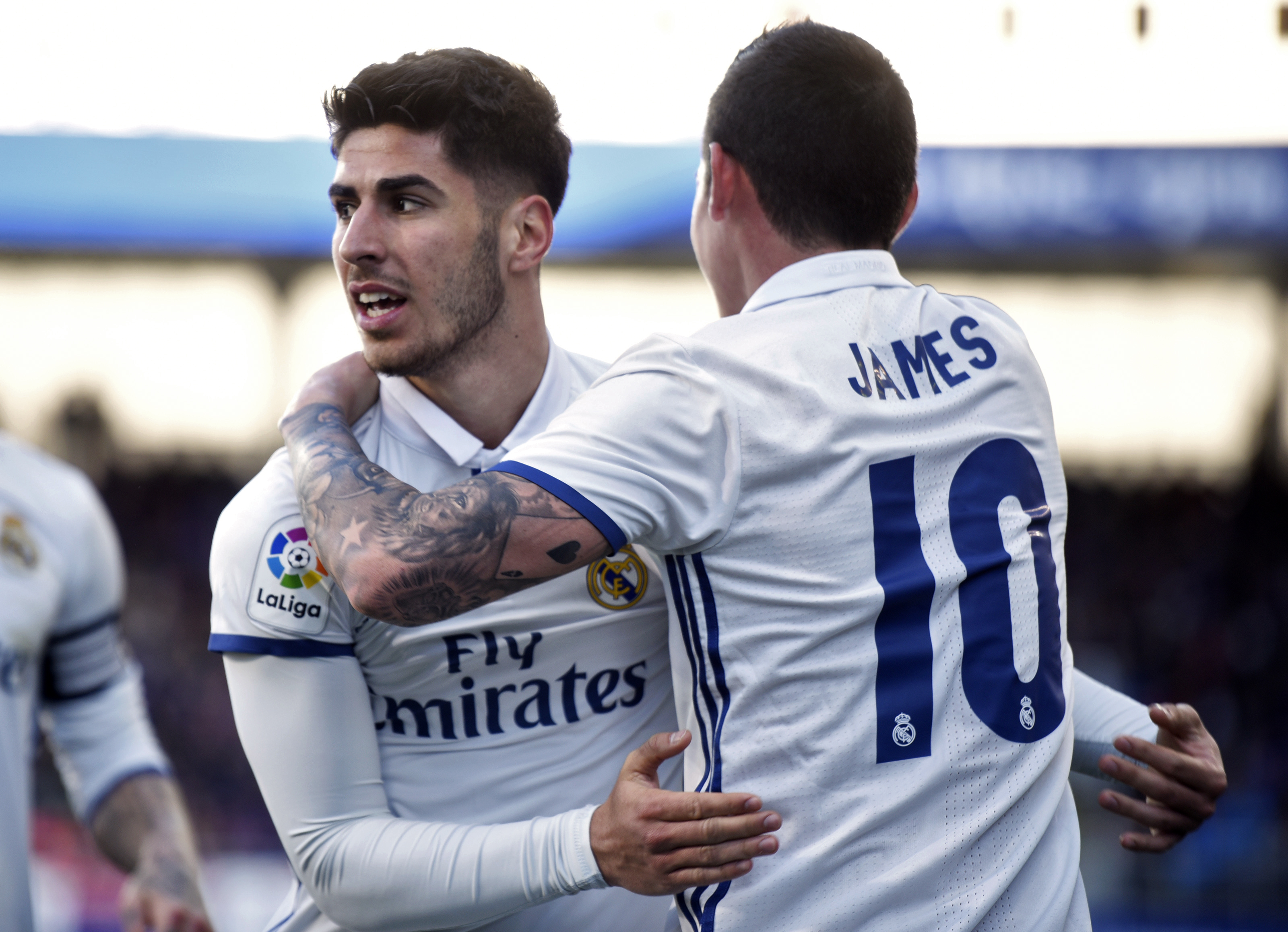 Real Madrid's midfielder Marco Asensio Willemsen (L) celebrates with Real Madrid's Colombian midfielder James Rodriguez after scoring his team's fourth goal during the Spanish league football match SD Eibar vs Real Madrid CF at the Ipurua stadium in Eibar on March 4, 2017. / AFP PHOTO / ANDER GILLENEA (Photo credit should read ANDER GILLENEA/AFP/Getty Images)