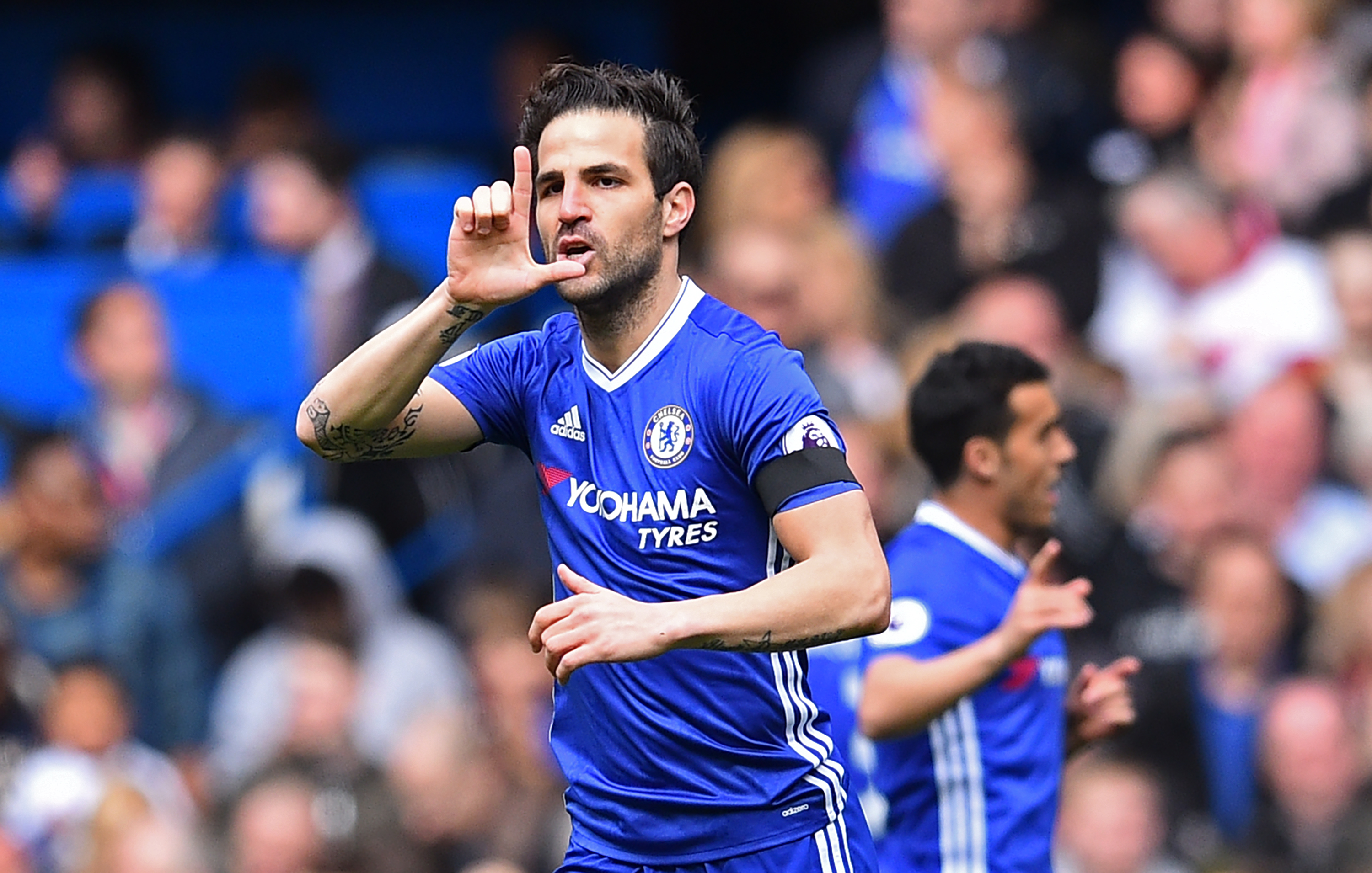 Chelsea's Spanish midfielder Cesc Fabregas celebrates after scoring the opening goal of the English Premier League football match between Chelsea and Crystal Palace at Stamford Bridge in London on April 1, 2017. / AFP PHOTO / Glyn KIRK / RESTRICTED TO EDITORIAL USE. No use with unauthorized audio, video, data, fixture lists, club/league logos or 'live' services. Online in-match use limited to 75 images, no video emulation. No use in betting, games or single club/league/player publications.  /         (Photo credit should read GLYN KIRK/AFP/Getty Images)