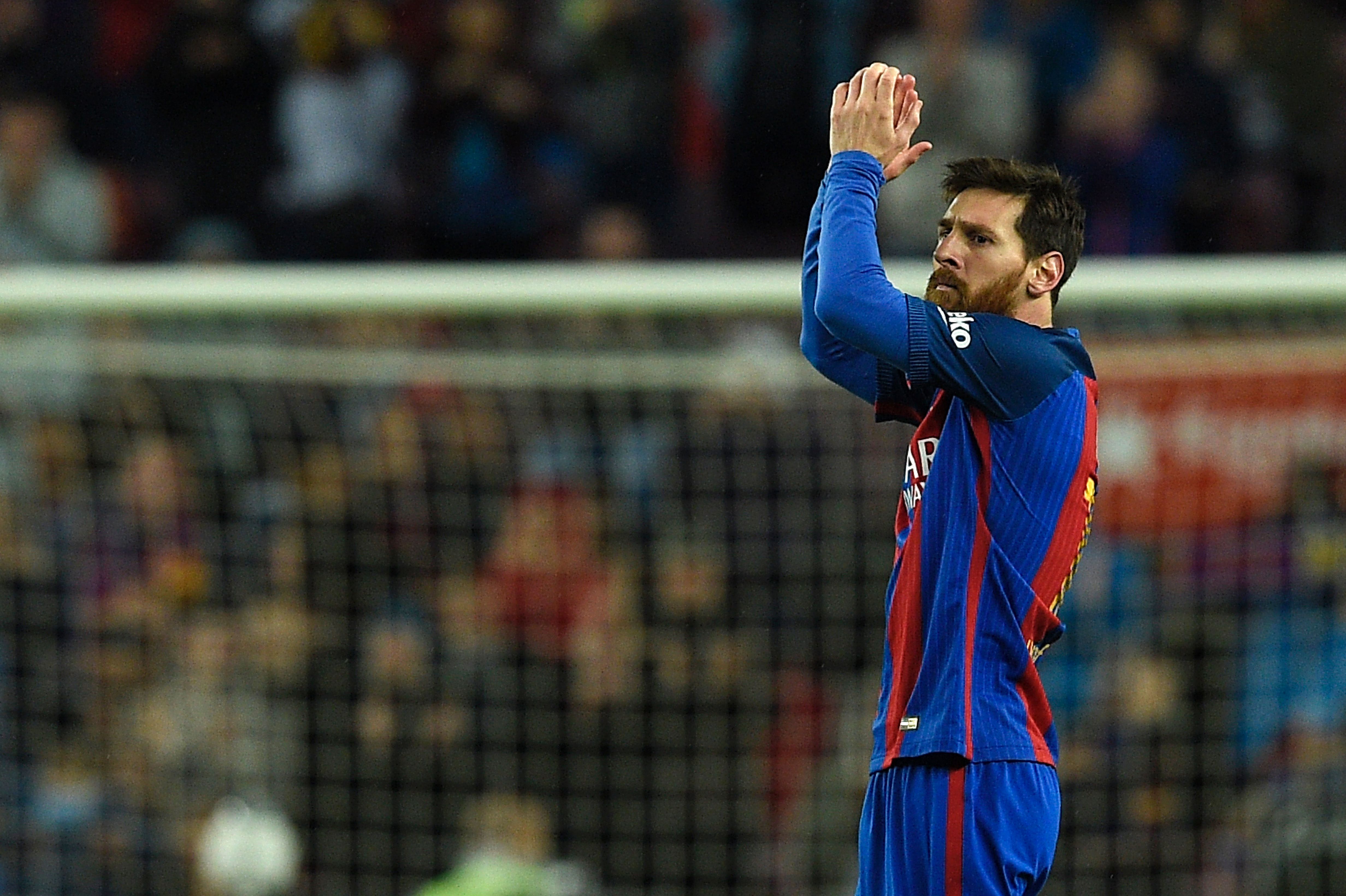 Barcelona's Argentinian forward Lionel Messi celebrates after scoring a goal during the Spanish league football match FC Barcelona vs CA Osasuna at the Camp Nou stadium in Barcelona on April 26, 2017. / AFP PHOTO / LLUIS GENE (Photo credit should read LLUIS GENE/AFP/Getty Images)