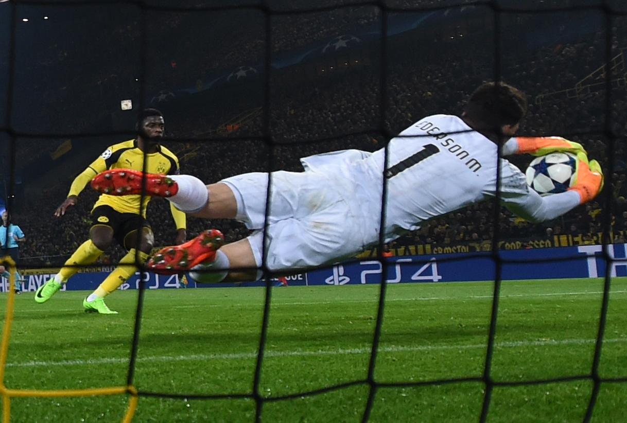 Benfica's Brazilian goalkeeper Ederson Moraes makes a save during the UEFA Champions League Round of 16, 2nd-leg football match Borussia Dortmund v SL Benfica in Dortmund, western Germany on March 8, 2017. / AFP PHOTO / PATRIK STOLLARZ (Photo credit should read PATRIK STOLLARZ/AFP/Getty Images)