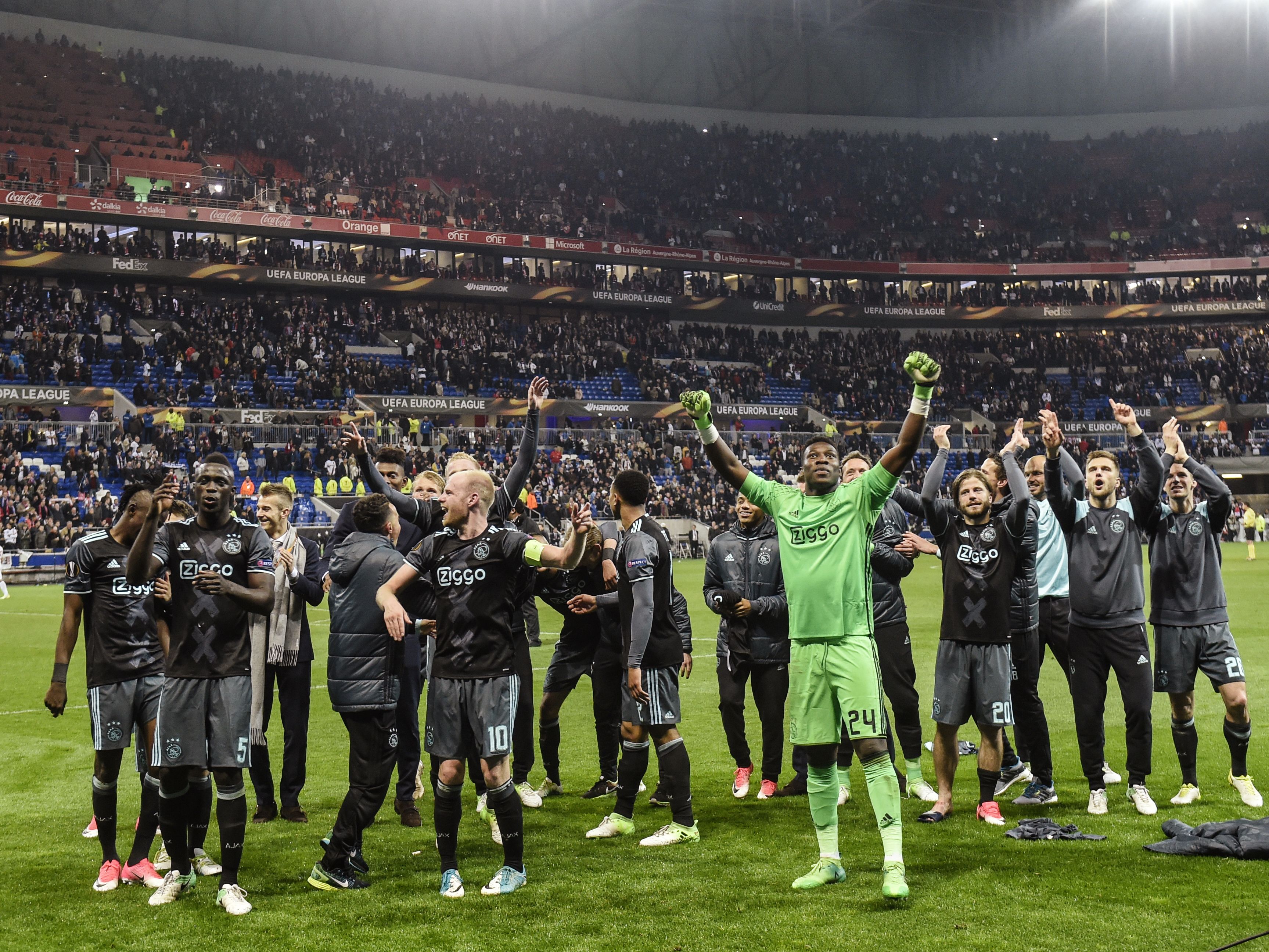 Ajax' players celebrate their victory in the Europa League semi-final football match Olympique Lyonnais against AFC Ajax, on May 11, 2017 at the Parc Olympique Lyonnais stadium in Décines-Charpieu near Lyon, southeastern France. / AFP PHOTO / PHILIPPE DESMAZES (Photo credit should read PHILIPPE DESMAZES/AFP/Getty Images)