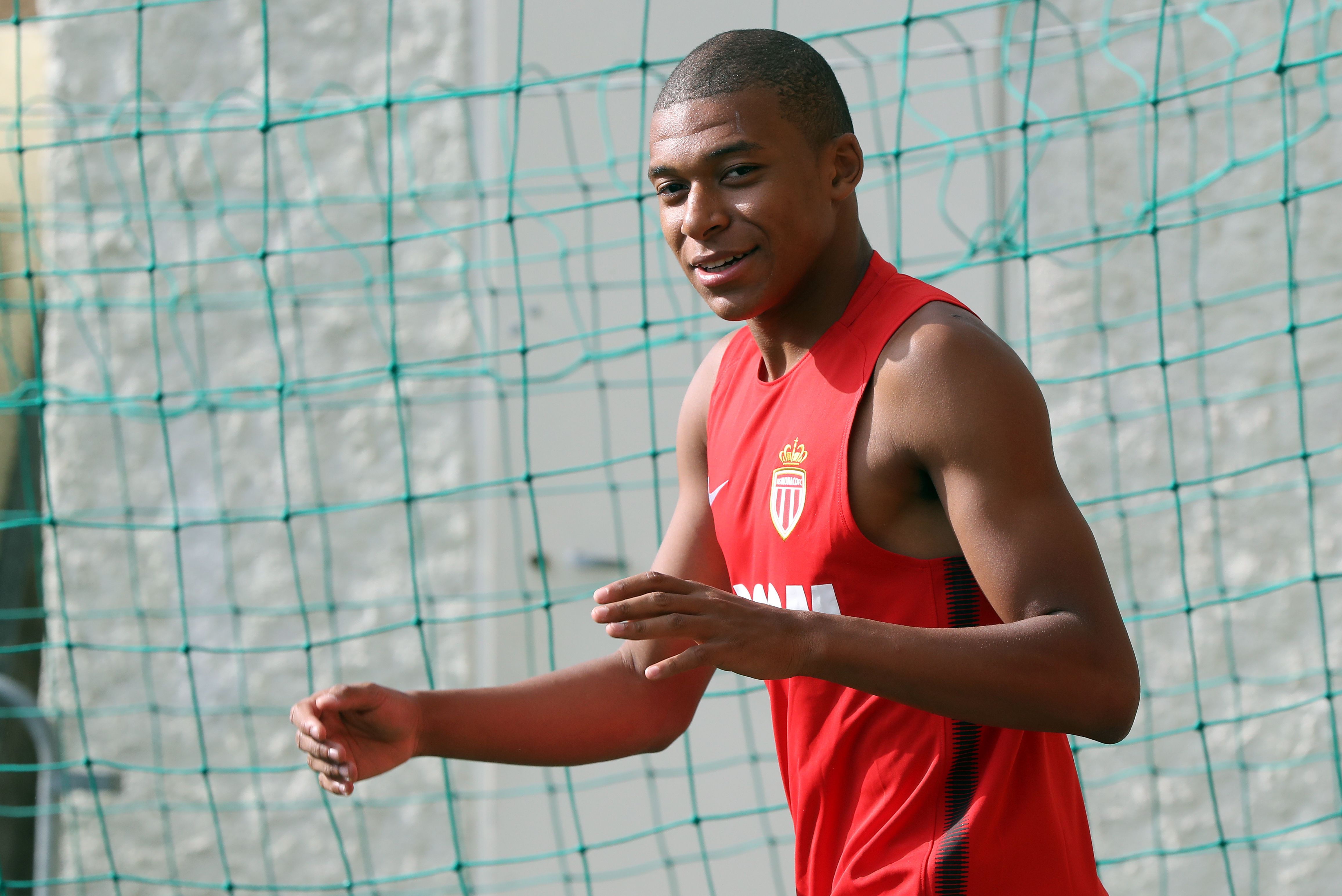 Monaco's French forward Kylian Mbappe arrives for a training session in La Turbie near Monaco on July 10, 2017.   / AFP PHOTO / VALERY HACHE        (Photo credit should read VALERY HACHE/AFP/Getty Images)