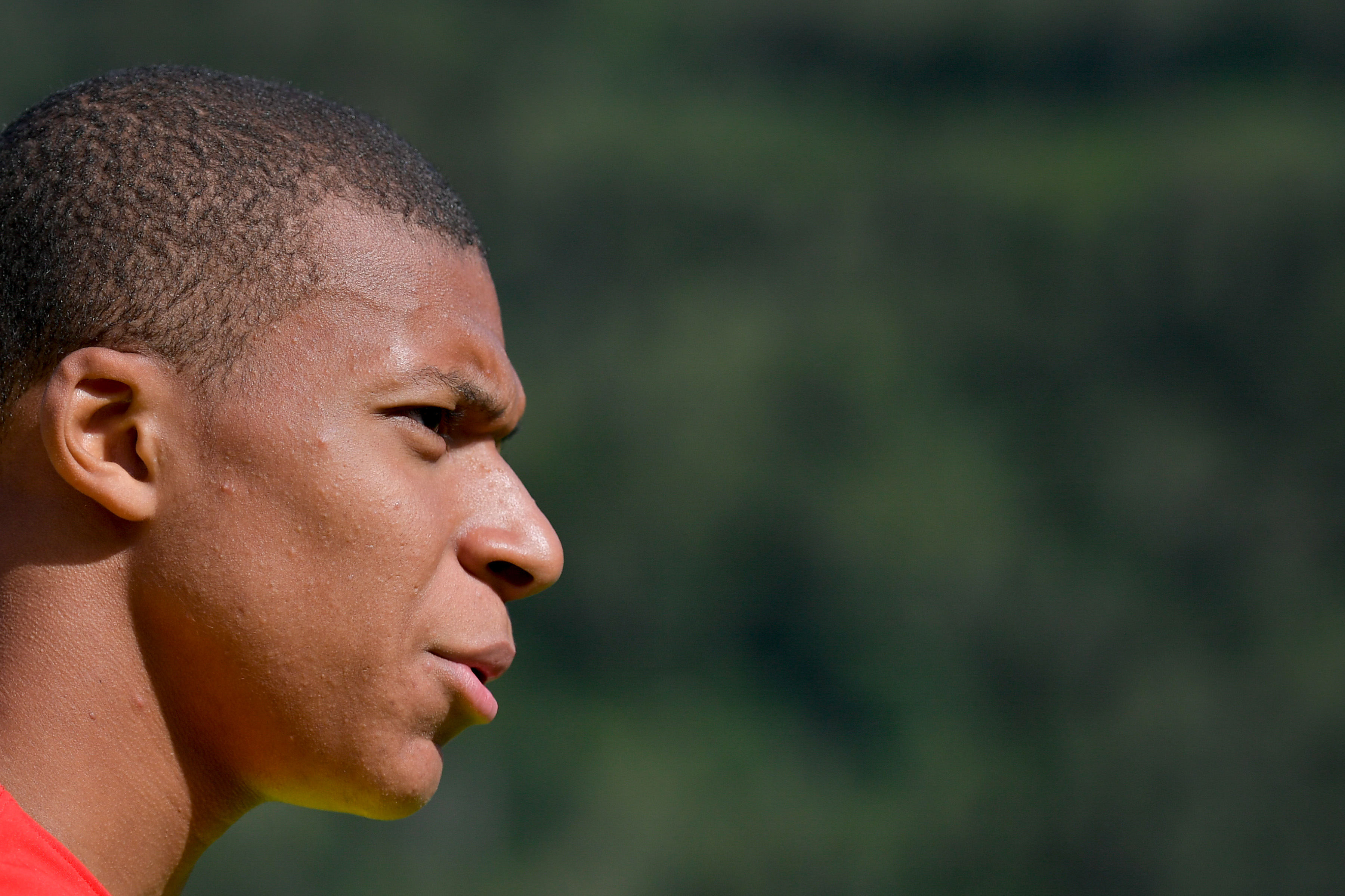 Monaco's forward Kylian Mbappe looks on prior to a friendly football match between AS Monaco and Stoke City FC in Martigny on July 15, 2017. / AFP PHOTO / Fabrice COFFRINI        (Photo credit should read FABRICE COFFRINI/AFP/Getty Images)