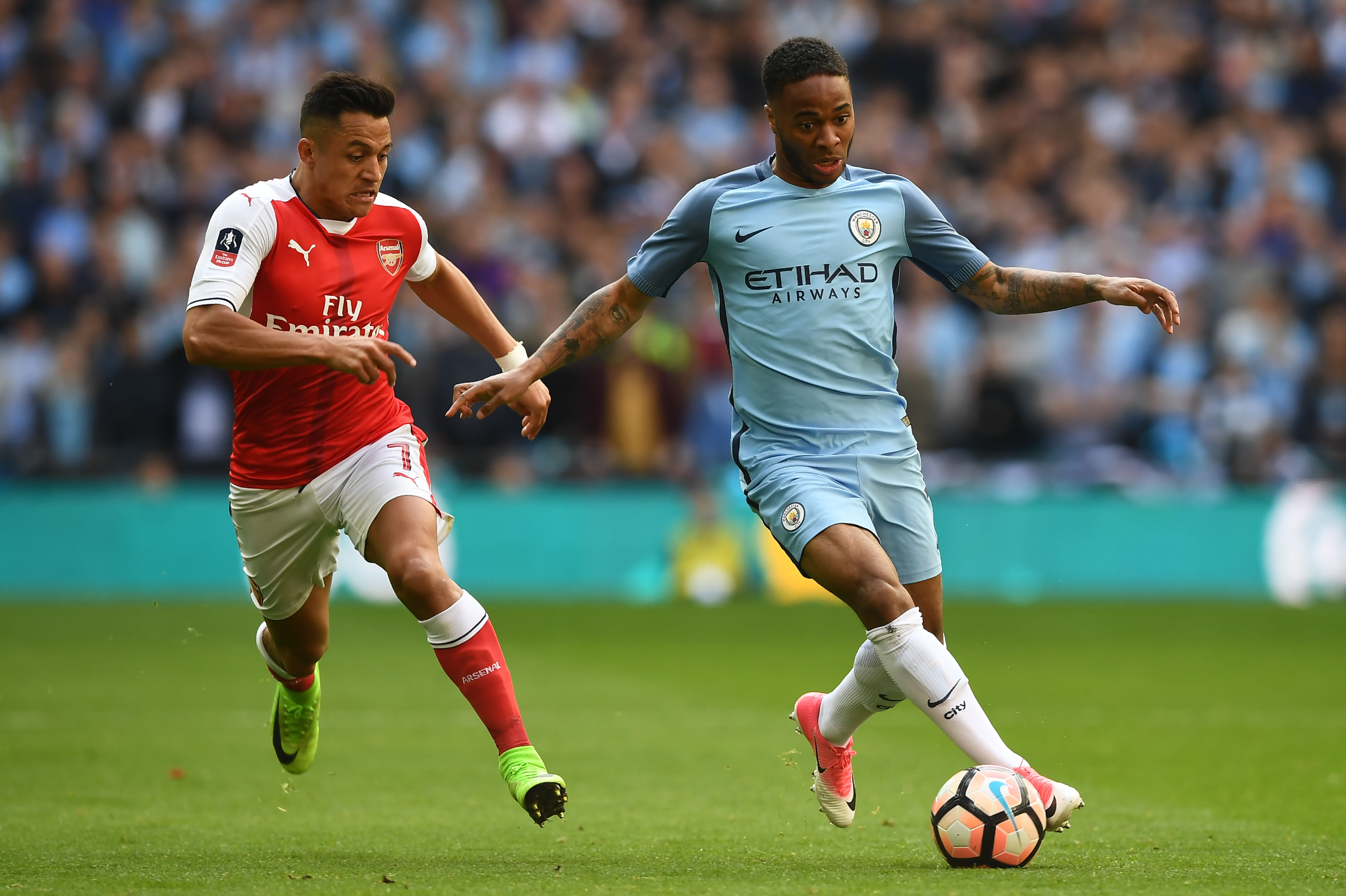 Arsenal's Chilean striker Alexis Sanchez (L) vies with Manchester City's English midfielder Raheem Sterling during the FA Cup semi-final football match between Arsenal and Manchester City at Wembley stadium in London on April 23, 2017. / AFP PHOTO / Justin TALLIS / NOT FOR MARKETING OR ADVERTISING USE / RESTRICTED TO EDITORIAL USE
        (Photo credit should read JUSTIN TALLIS/AFP/Getty Images)