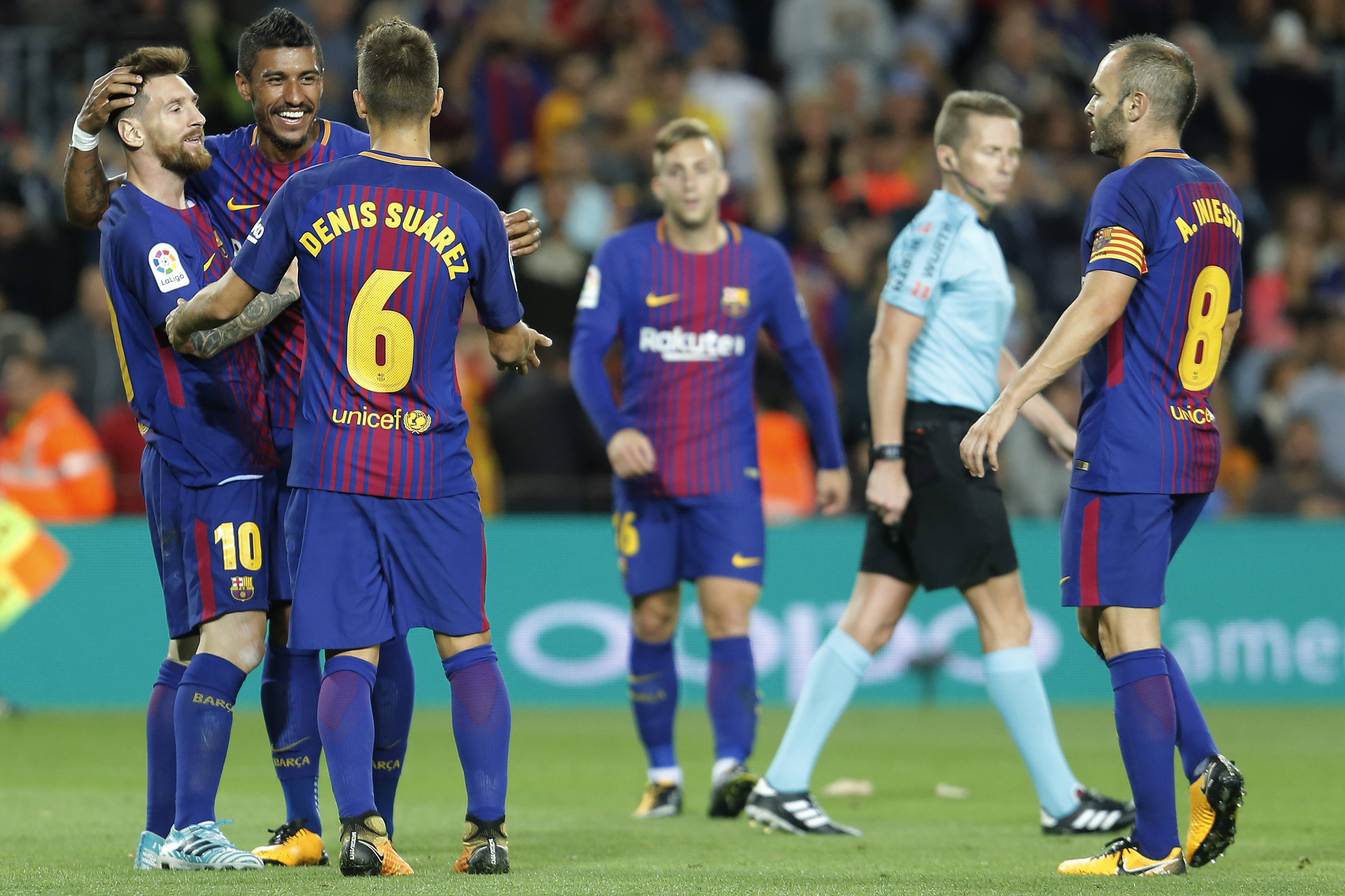 Barcelona's forward from Argentina Lionel Messi (L) celebrates with teammates after scoring during the Spanish league football match FC Barcelona against SD Eibar at the Camp Nou stadium in Barcelona on September 19, 2017. / AFP PHOTO / PAU BARRENA        (Photo credit should read PAU BARRENA/AFP/Getty Images)