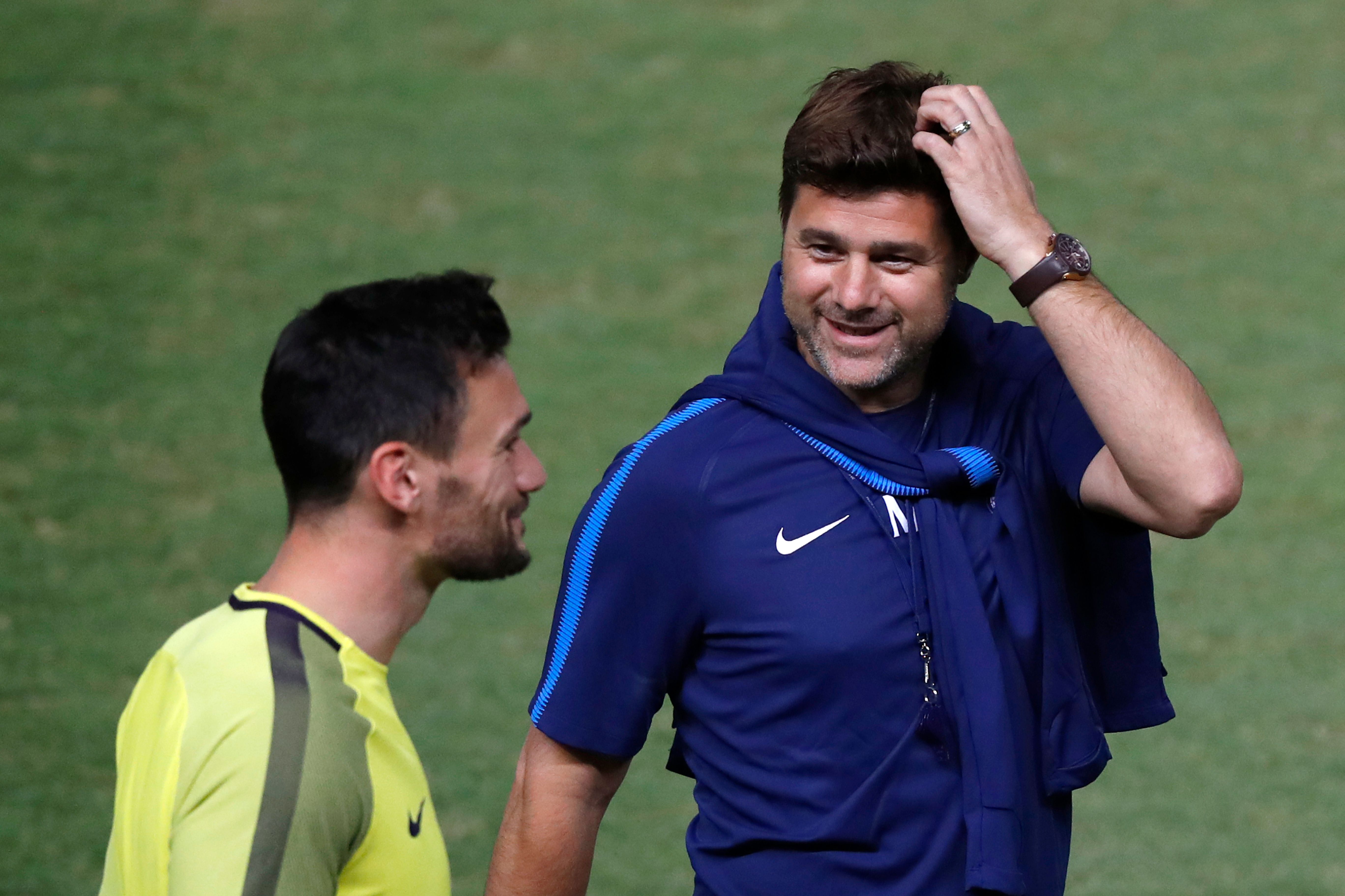 Tottenham Hotspur's French goalkeeper Hugo Lloris (L) and Tottenham Hotspur's Argentine Head Coach Mauricio Pochettino (R) take part in a training session at the GSP Stadium in Nicosia, on the eve of the UEFA Champions League Group H football match between Apoel FC and Tottenham Hotspur, on September 25, 2017. / AFP PHOTO / JACK GUEZ        (Photo credit should read JACK GUEZ/AFP/Getty Images)