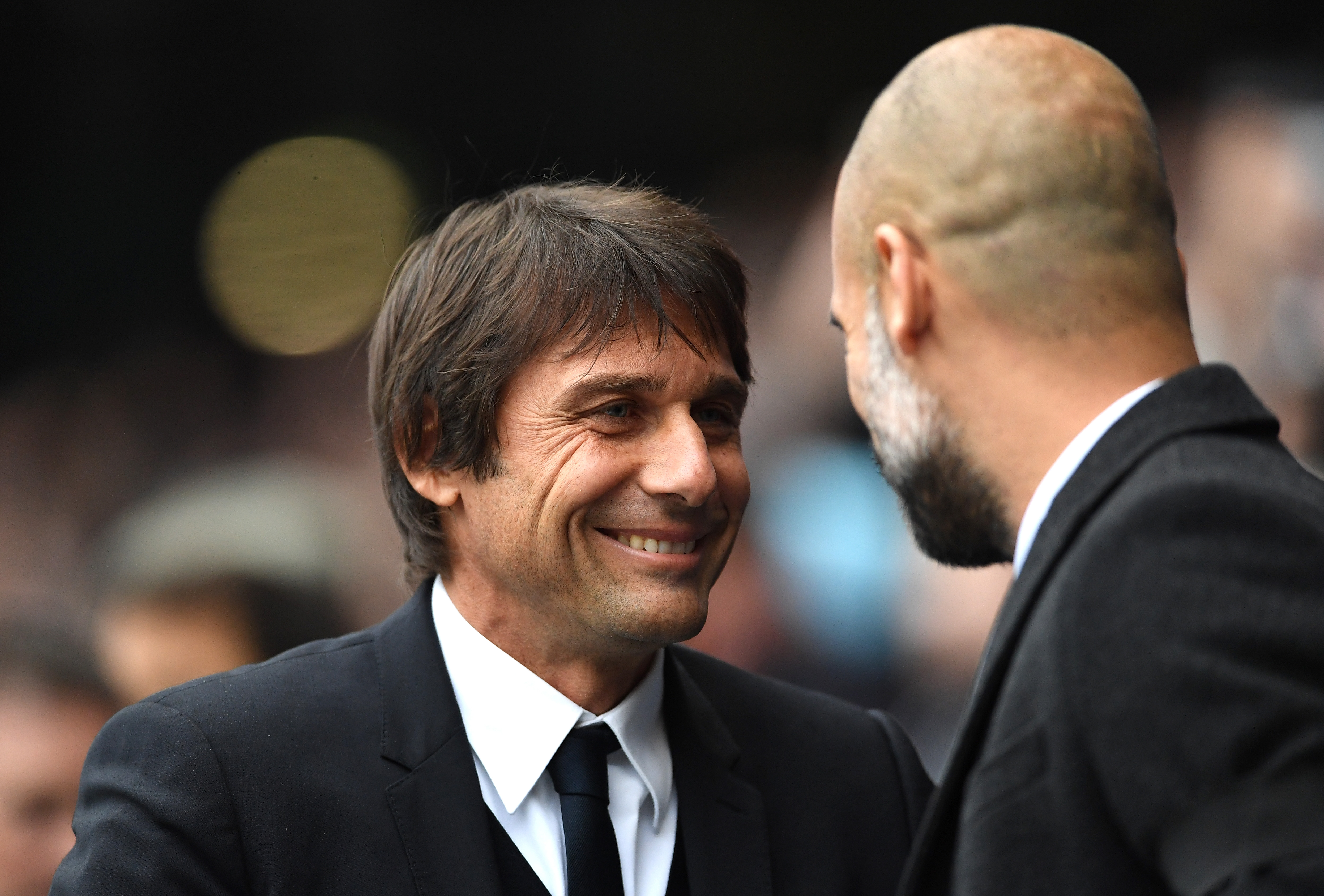 MANCHESTER, ENGLAND - DECEMBER 03:  Antonio Conte, Manager of Chelsea and Josep Guardiola, Manager of Manchester City greet prior to the Premier League match between Manchester City and Chelsea at Etihad Stadium on December 3, 2016 in Manchester, England.  (Photo by Laurence Griffiths/Getty Images)