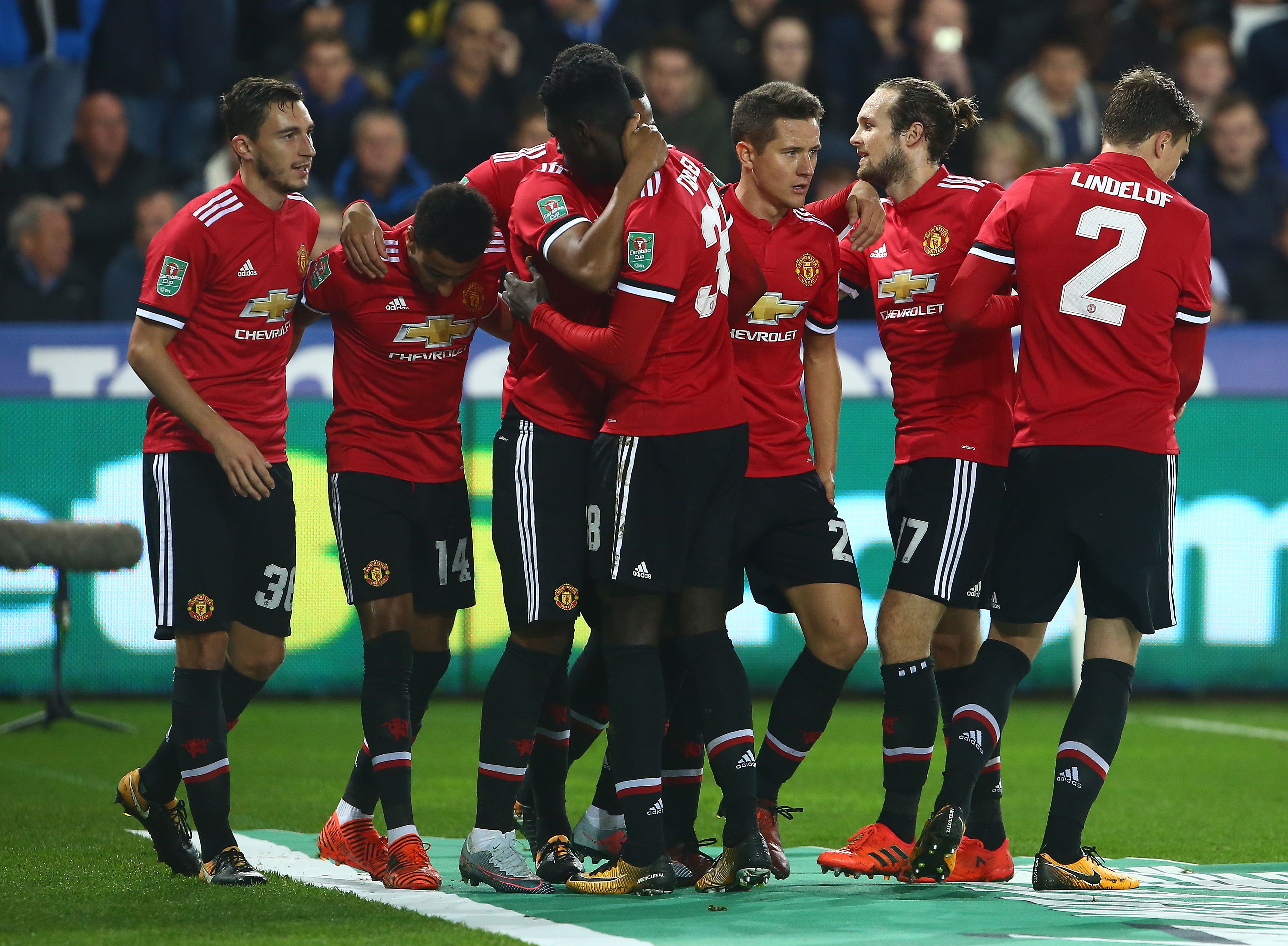 Manchester United's English midfielder Jesse Lingard (2L) celebrates scoring his team's second goal during the English League Cup fourth round football match between Swansea City and Manchester United at The Liberty Stadium in Swansea, south Wales on October 24, 2017. / AFP PHOTO / Geoff CADDICK / RESTRICTED TO EDITORIAL USE. No use with unauthorized audio, video, data, fixture lists, club/league logos or 'live' services. Online in-match use limited to 75 images, no video emulation. No use in betting, games or single club/league/player publications.  /         (Photo credit should read GEOFF CADDICK/AFP/Getty Images)