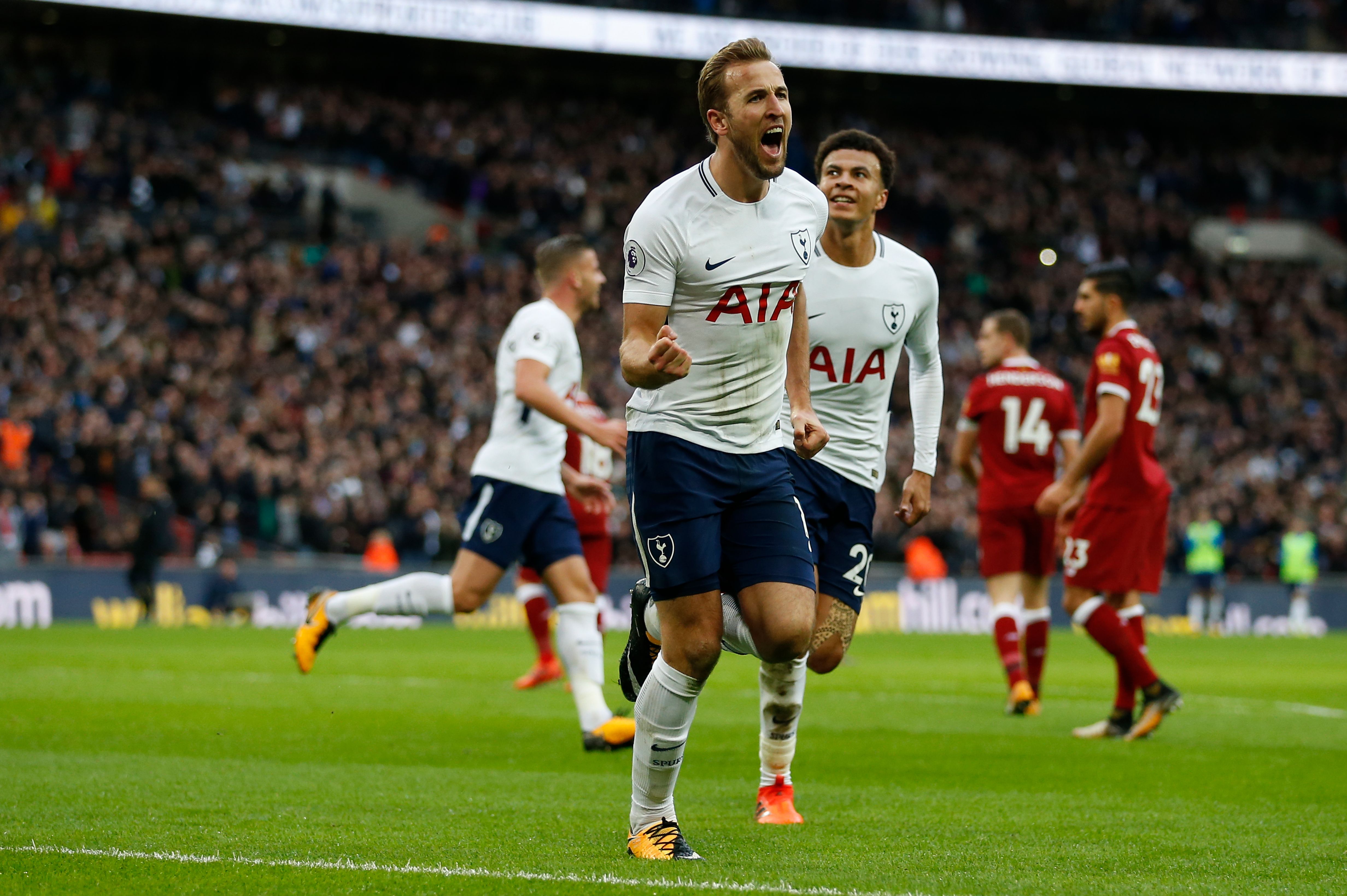 Tottenham Hotspur's English striker Harry Kane (C) celebrates after scoring their fourth goal during the English Premier League football match between Tottenham Hotspur and Liverpool at Wembley Stadium in London, on October 22, 2017. / AFP PHOTO / IKIMAGES / Ian KINGTON / RESTRICTED TO EDITORIAL USE. No use with unauthorized audio, video, data, fixture lists, club/league logos or 'live' services. Online in-match use limited to 45 images, no video emulation. No use in betting, games or single club/league/player publications. / (Photo credit should read IAN KINGTON/AFP/Getty Images)