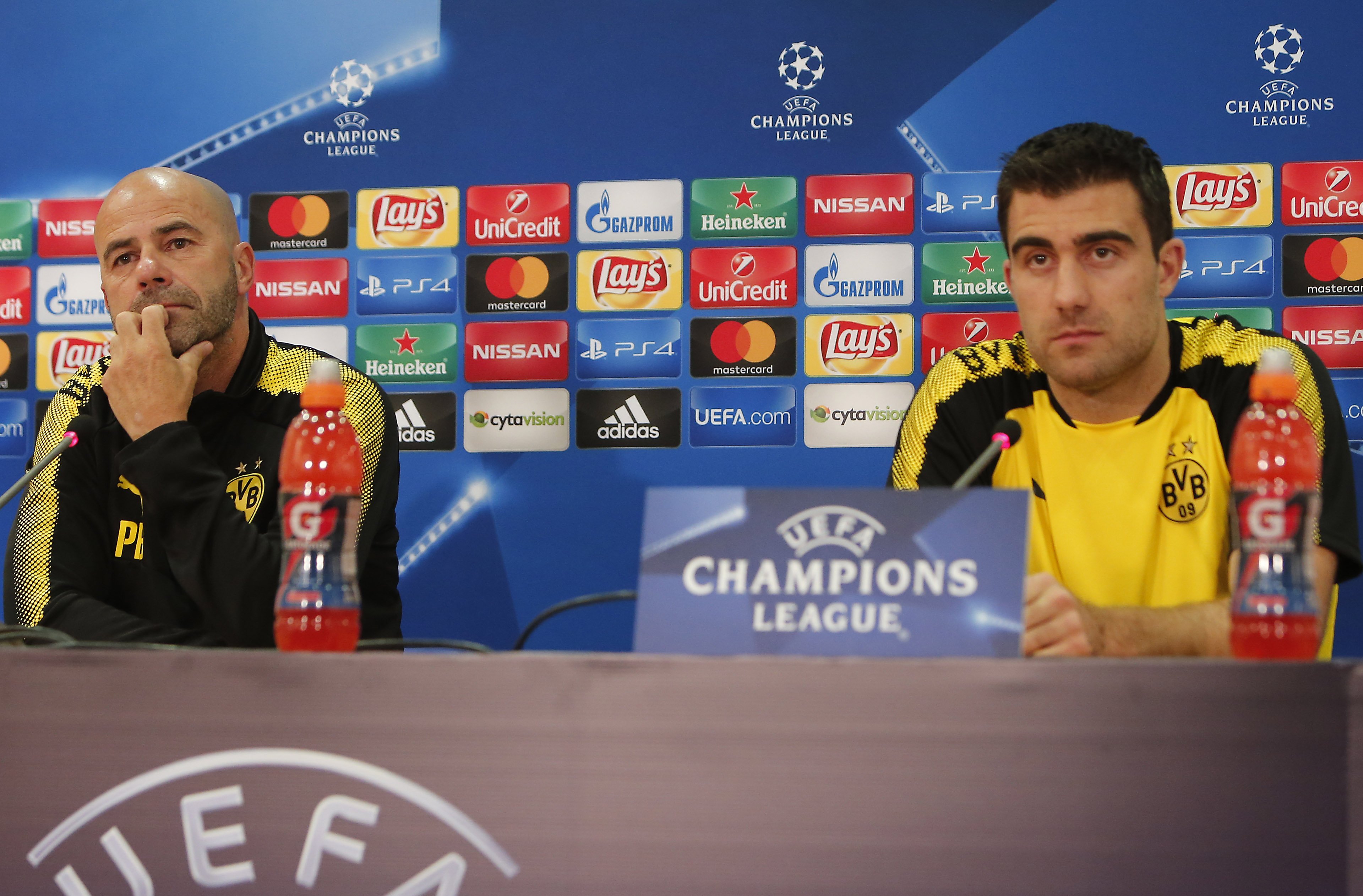 Dortmund's Dutch head coach Peter Bosz and player Sokratis Papastathopoulos hold a press conference on the eve of the UEFA Champions League football match between Apoel FC and Borussia Dortmund at the GSP Stadium in the Cypriot capital Nicosia, on October 16, 2017.  / AFP PHOTO / Florian CHOBLET        (Photo credit should read FLORIAN CHOBLET/AFP/Getty Images)
