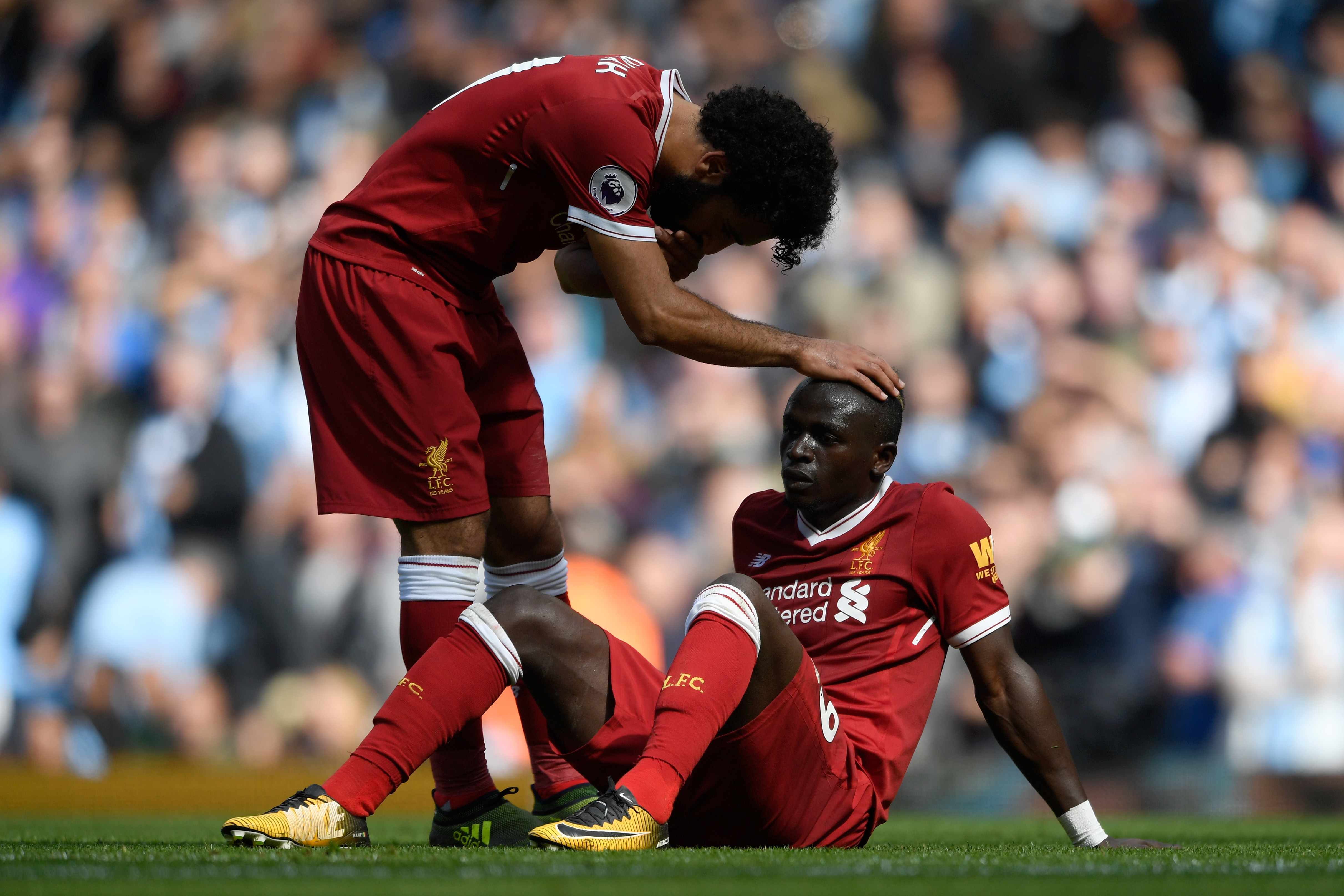 MANCHESTER, ENGLAND - SEPTEMBER 09: Mohamed Salah of Liverpool comforts Sadio Mane of Liverpool after he reacts to being sent off during the Premier League match between Manchester City and Liverpool at Etihad Stadium on September 9, 2017 in Manchester, England. (Photo by Stu Forster/Getty Images)