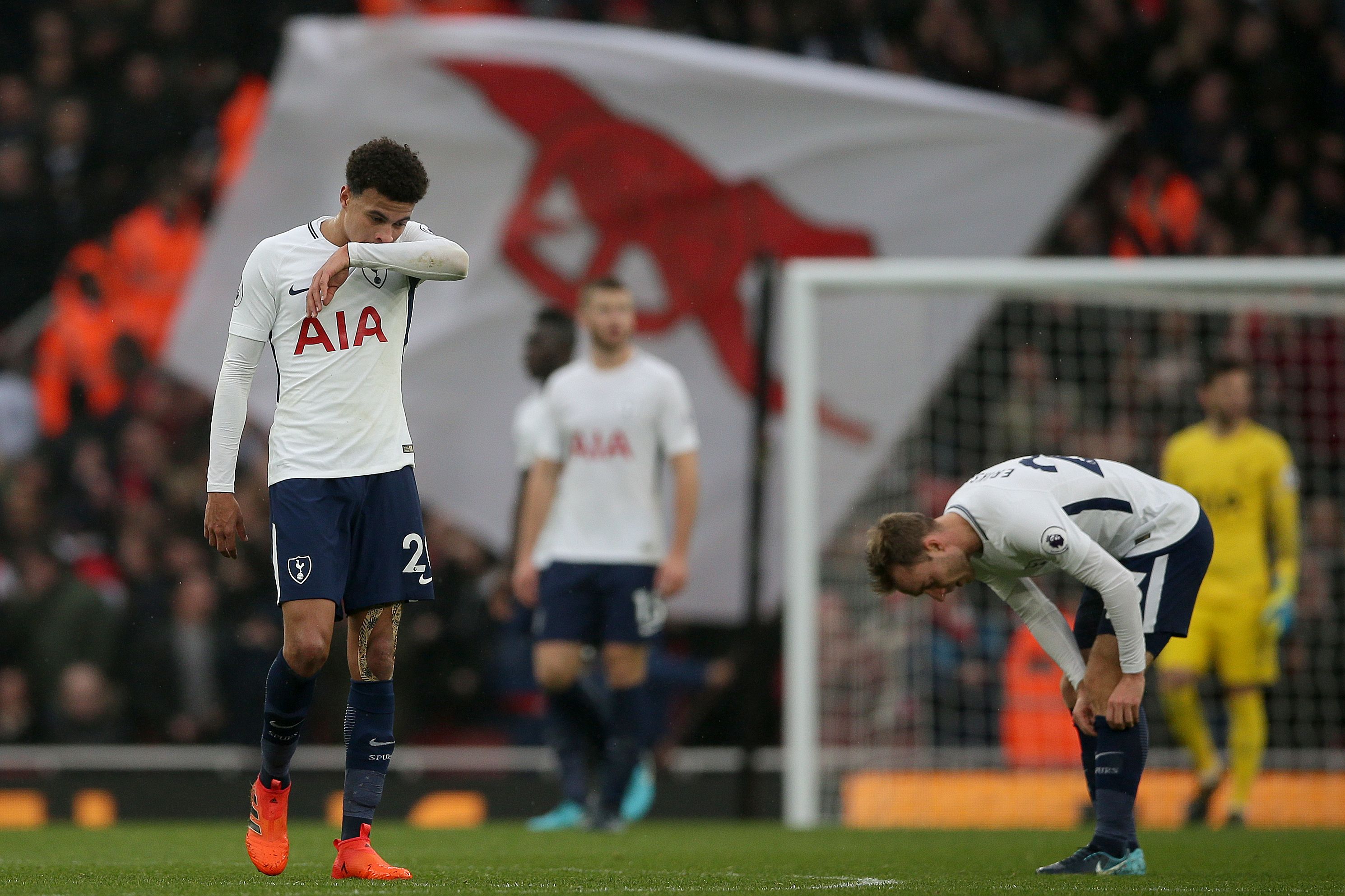 Tottenham Hotspur's English midfielder Dele Alli (L) reacts after Arsenal's second goal during the English Premier League football match between Arsenal and Tottenham Hotspur at the Emirates Stadium in London on November 18, 2017.  / AFP PHOTO / Daniel LEAL-OLIVAS / RESTRICTED TO EDITORIAL USE. No use with unauthorized audio, video, data, fixture lists, club/league logos or 'live' services. Online in-match use limited to 75 images, no video emulation. No use in betting, games or single club/league/player publications.  /         (Photo credit should read DANIEL LEAL-OLIVAS/AFP/Getty Images)