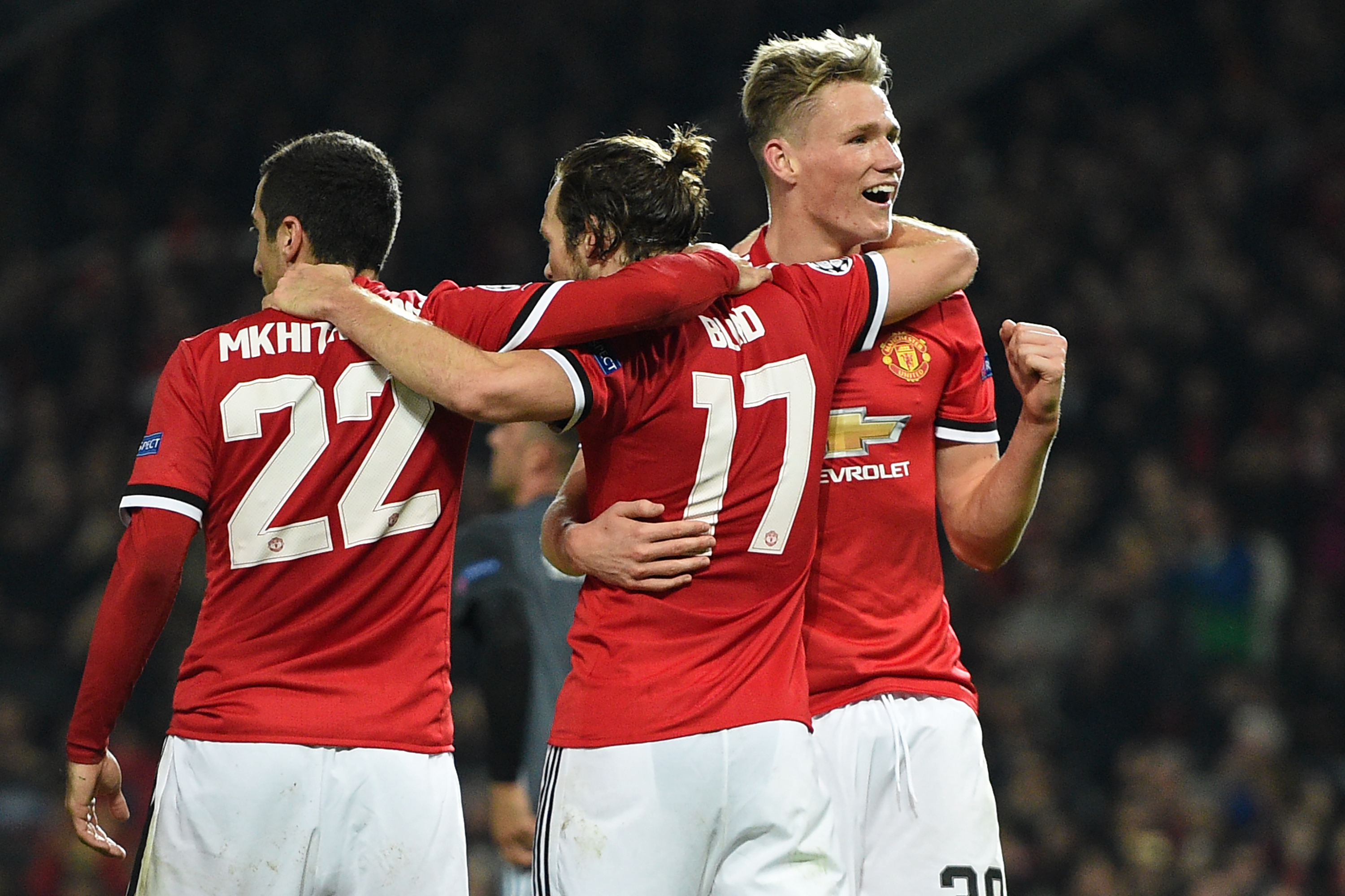 Manchester United's Dutch midfielder Daley Blind (C) celebrates with Manchester United's Armenian midfielder Henrikh Mkhitaryan (L) and Manchester United's English midfielder Scott McTominay (R) after scoring their second goal from the penalty spot during the UEFA Champions League Group A football match between Manchester United and Benfica at Old Trafford in Manchester, north west England on October 31, 2017.
Manchester United won the game 2-0. / AFP PHOTO / Oli SCARFF        (Photo credit should read OLI SCARFF/AFP/Getty Images)