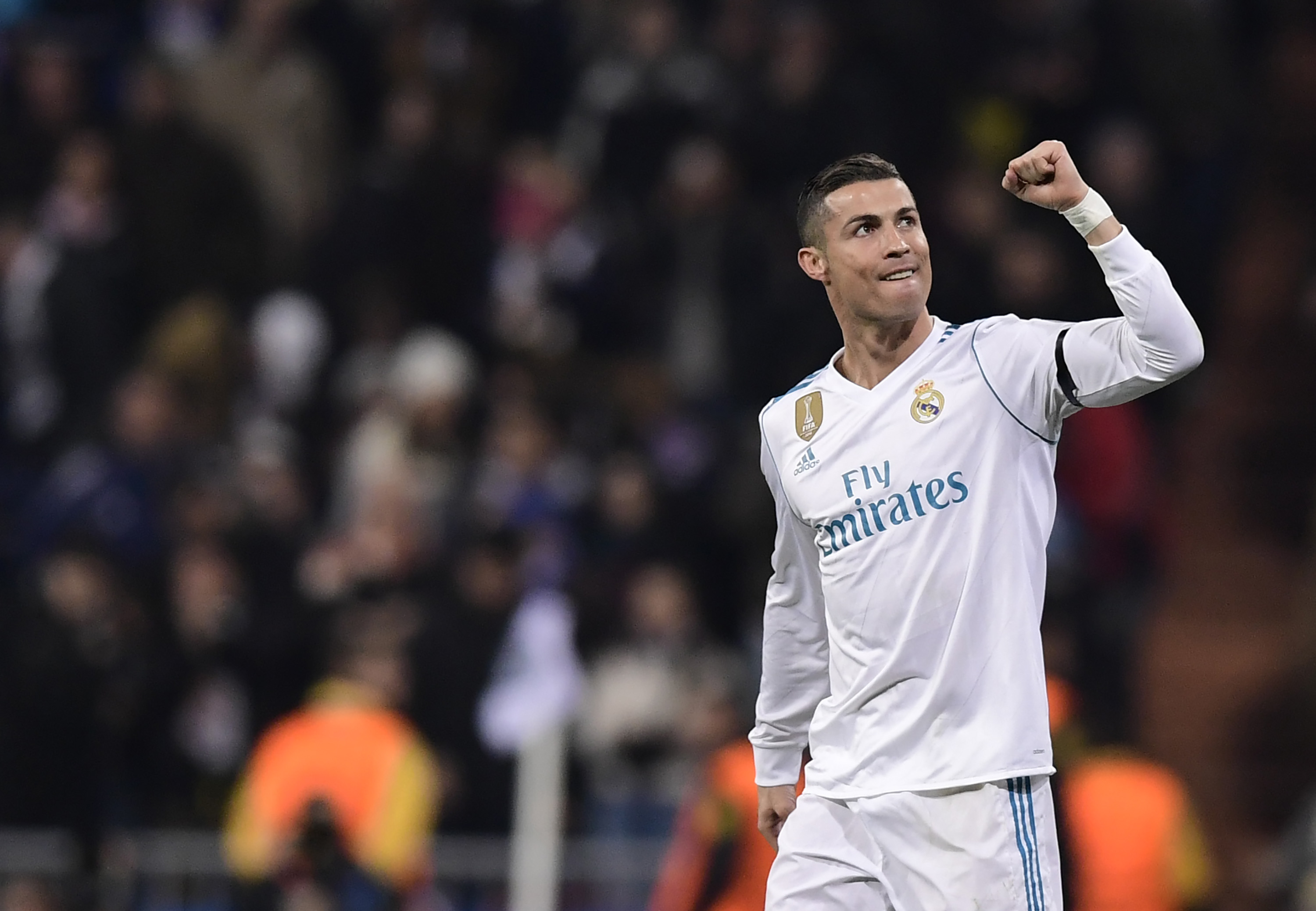 Real Madrid's Portuguese forward Cristiano Ronaldo celebrates a goal during the UEFA Champions League group H football match Real Madrid CF vs Borussia Dortmund at the Santiago Bernabeu stadium in Madrid on December 6, 2017. / AFP PHOTO / JAVIER SORIANO