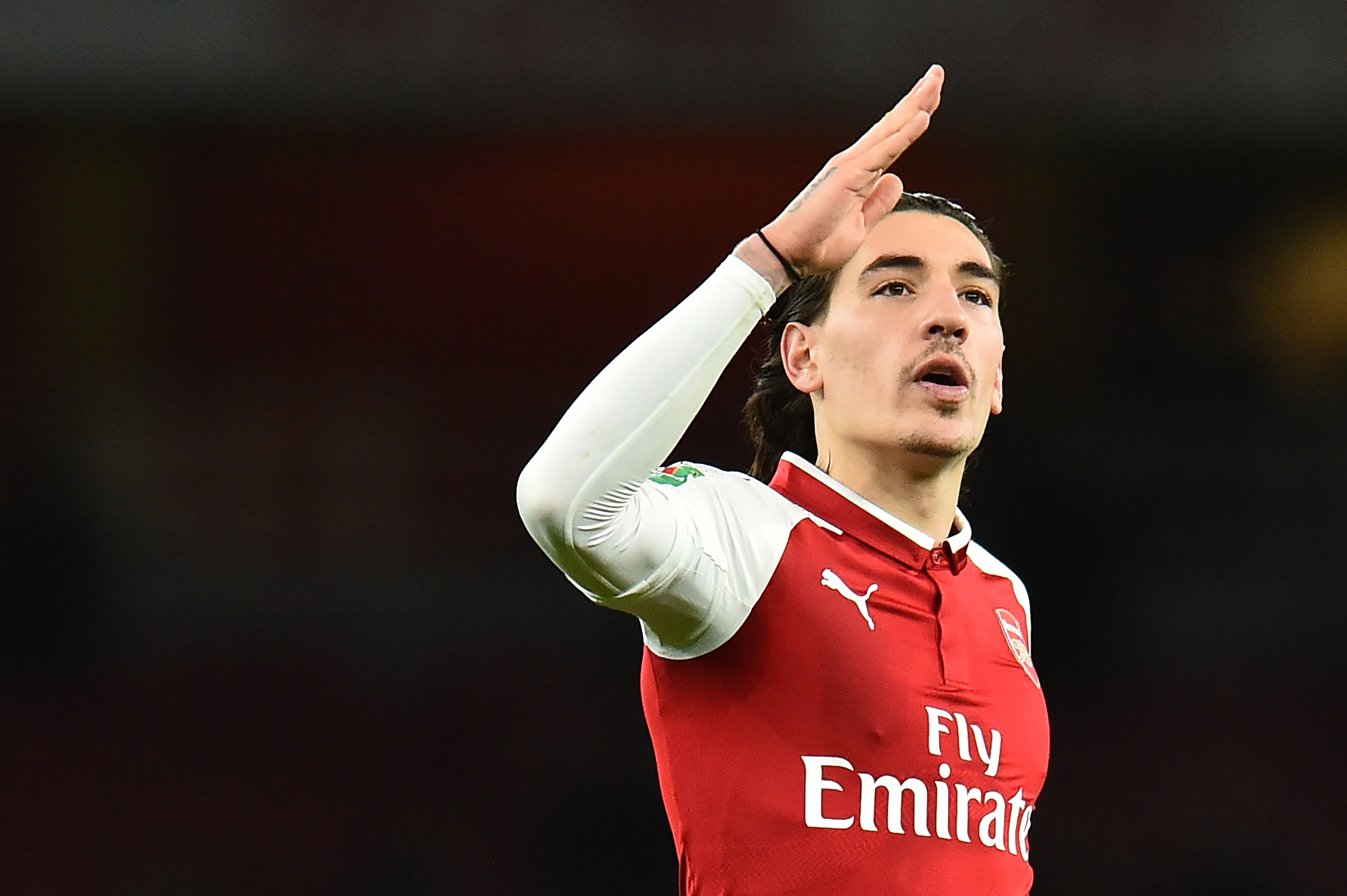 Arsenal's Spanish defender Hector Bellerin gestures at the final whistle during the League Cup semi-final football match between Arsenal and Chelsea at the Emirates Stadium in London on January 24, 2018. / AFP PHOTO / Glyn KIRK / RESTRICTED TO EDITORIAL USE. No use with unauthorized audio, video, data, fixture lists, club/league logos or 'live' services. Online in-match use limited to 75 images, no video emulation. No use in betting, games or single club/league/player publications. / (Photo credit should read GLYN KIRK/AFP/Getty Images)