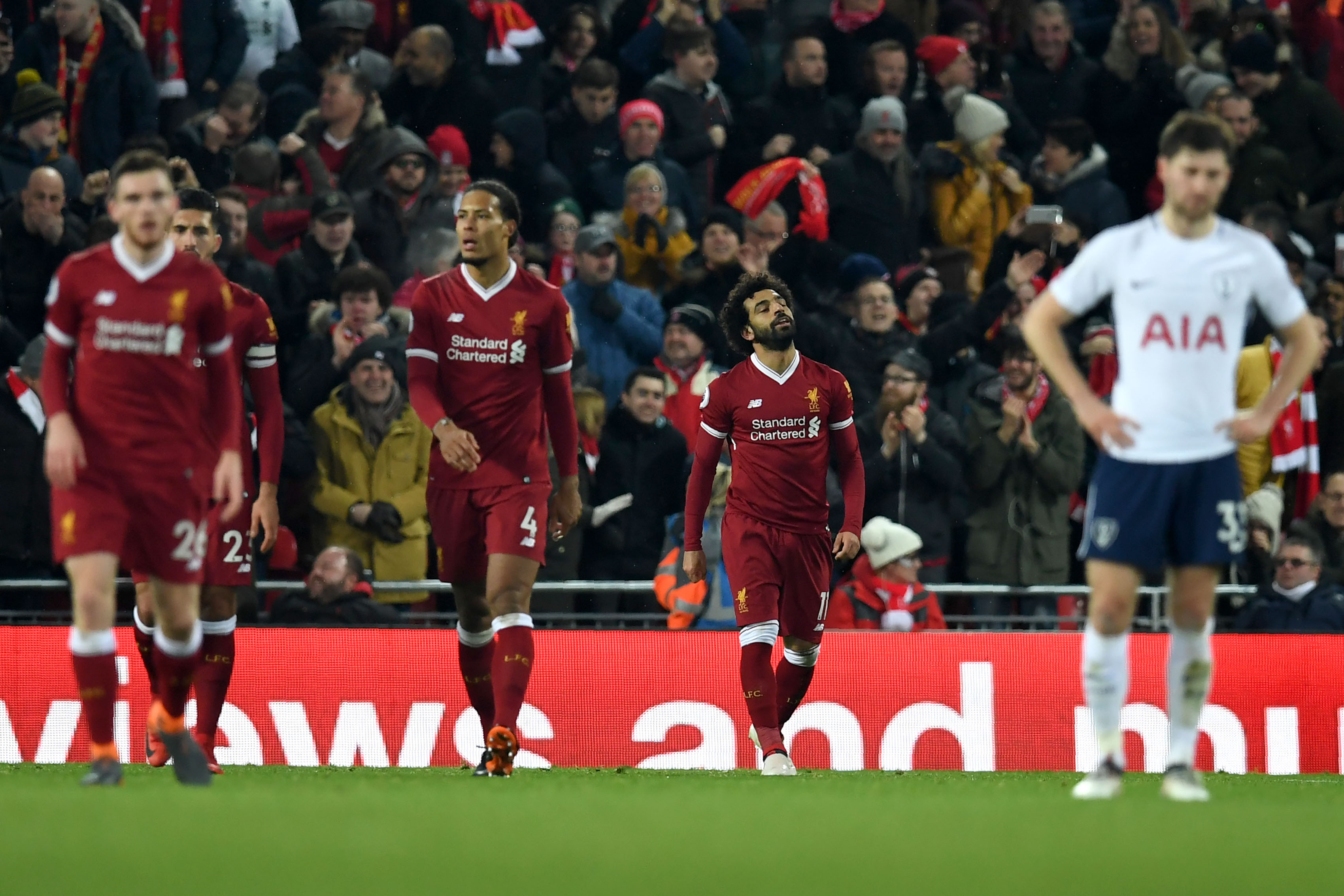 Liverpool's Egyptian midfielder Mohamed Salah (2R) celebrates scoring his team's second goal during the English Premier League football match between Liverpool and Tottenham Hotspur at Anfield in Liverpool, north west England on February 4, 2018. / AFP PHOTO / Paul ELLIS / RESTRICTED TO EDITORIAL USE. No use with unauthorized audio, video, data, fixture lists, club/league logos or 'live' services. Online in-match use limited to 75 images, no video emulation. No use in betting, games or single club/league/player publications. / (Photo credit should read PAUL ELLIS/AFP/Getty Images)
