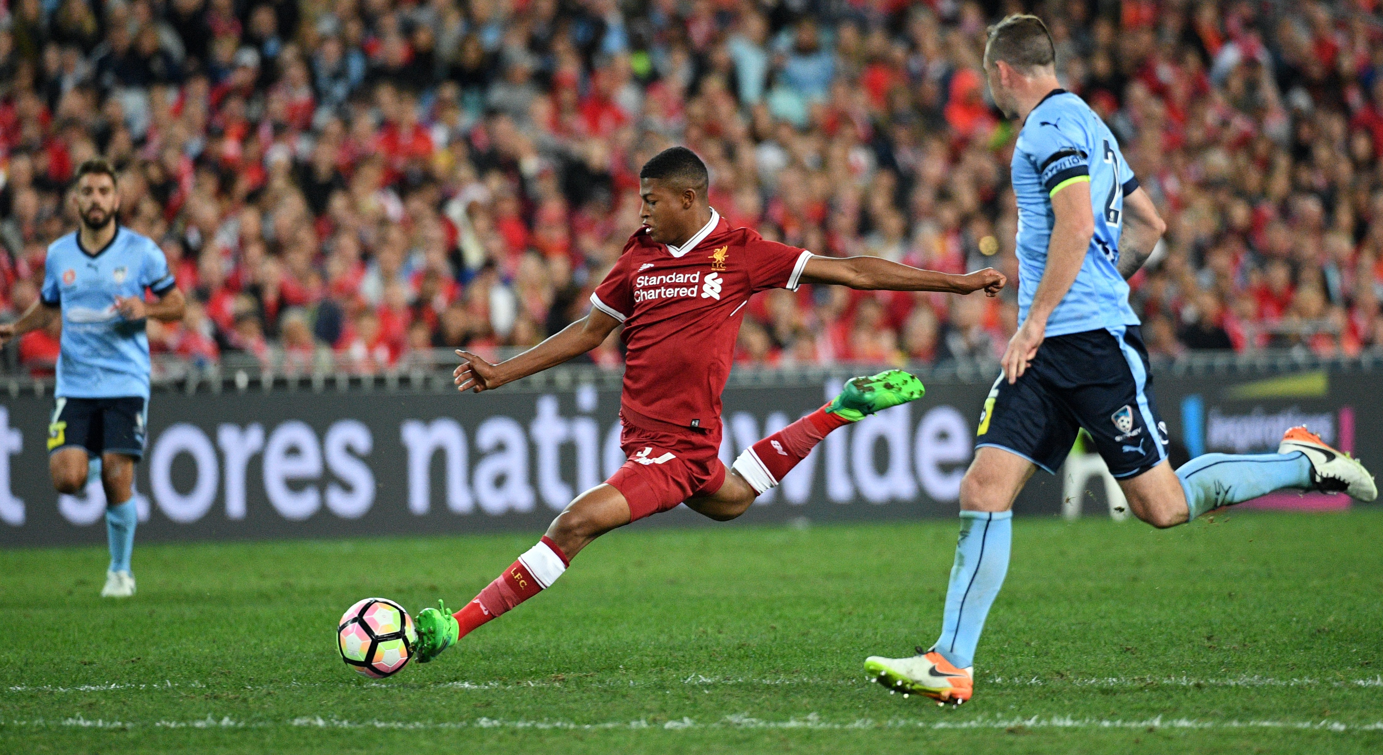 Liverpool player Rhian Brewster (C) shoots on goal as Sydney FC player Sebastian Ryall (R) looks on during their end-of-season friendly football match at the Olympic Stadium in Sydney on May 24, 2017. / AFP PHOTO / WILLIAM WEST / IMAGE RESTRICTED TO EDITORIAL USE - STRICTLY NO COMMERCIAL USE        (Photo credit should read WILLIAM WEST/AFP/Getty Images)