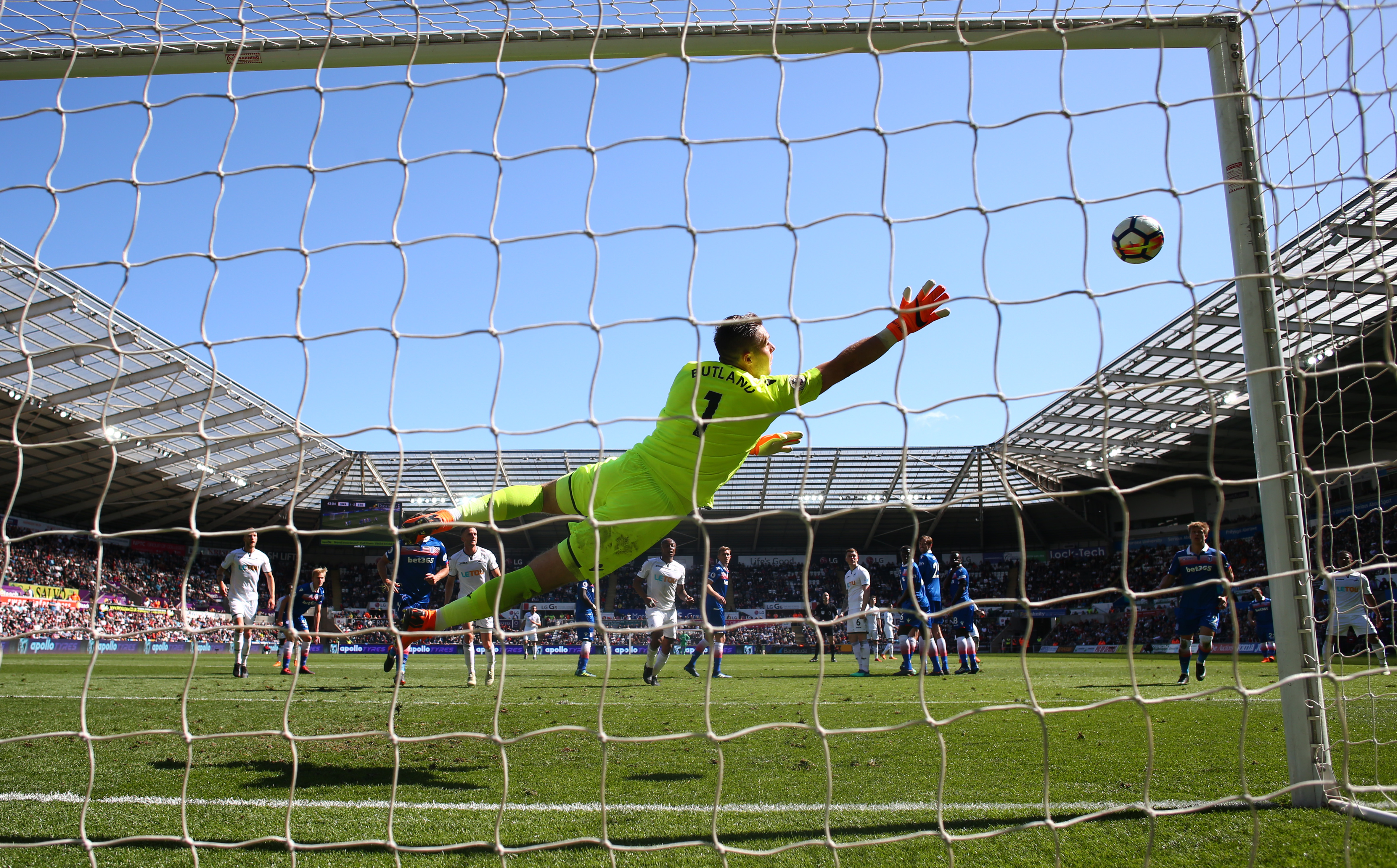 SWANSEA, WALES - MAY 13: Jack Butland of Stoke City dives to make a save during the Premier League match between Swansea City and Stoke City at Liberty Stadium on May 13, 2018 in Swansea, Wales. (Photo by Michael Steele/Getty Images)