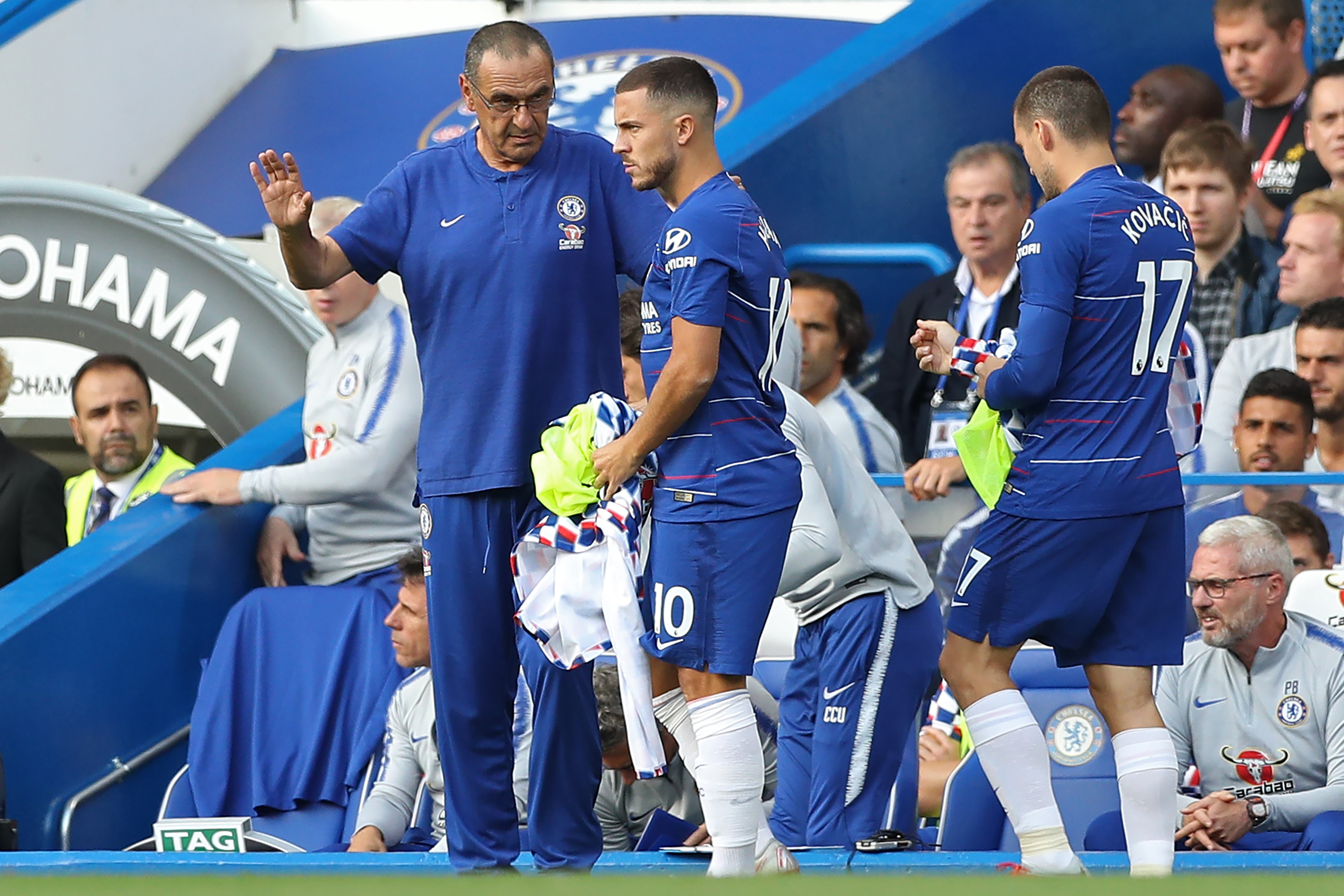Chelsea's Italian head coach Maurizio Sarri (L) prepares to bring on Chelsea's Belgian midfielder Eden Hazard (C) and Chelsea's Croatian midfielder Mateo Kovacic (R) during the English Premier League football match between Chelsea and Arsenal at Stamford Bridge in London on August 18, 2018. (Photo by Daniel LEAL-OLIVAS / AFP) / RESTRICTED TO EDITORIAL USE. No use with unauthorized audio, video, data, fixture lists, club/league logos or 'live' services. Online in-match use limited to 120 images. An additional 40 images may be used in extra time. No video emulation. Social media in-match use limited to 120 images. An additional 40 images may be used in extra time. No use in betting publications, games or single club/league/player publications. / (Photo credit should read DANIEL LEAL-OLIVAS/AFP/Getty Images)