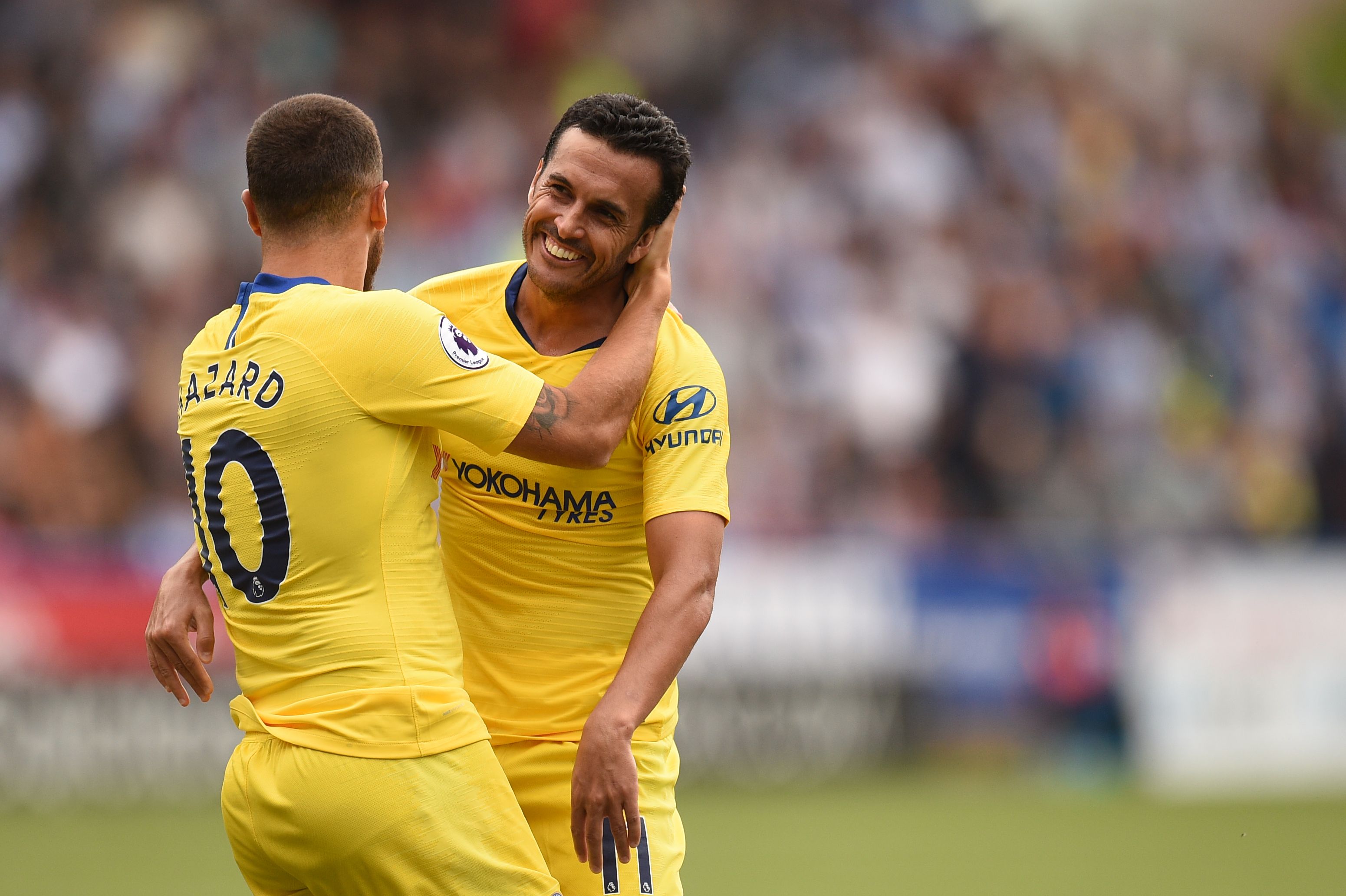 Chelsea's Spanish midfielder Pedro (R) celebrates with Chelsea's Belgian midfielder Eden Hazard after scoring the team's third goal past Huddersfield Town's English goalkeeper Ben Hamer during the English Premier League football match between Huddersfield Town and Chelsea at the John Smith's stadium in Huddersfield, northern England on August 11, 2018. (Photo by Oli SCARFF / AFP) / RESTRICTED TO EDITORIAL USE.No use with unauthorized audio, video, data, fixture lists, club/league logos or 'live' services. Online in-match use limited to 120 images. An additional 40 images may be used in extra time. No video emulation. Social media in-match use limited to 120 images. An additional 40 images may be used in extra time. No use in betting publications, games or single club/league/player publications/ / (Photo credit should read OLI SCARFF/AFP/Getty Images)