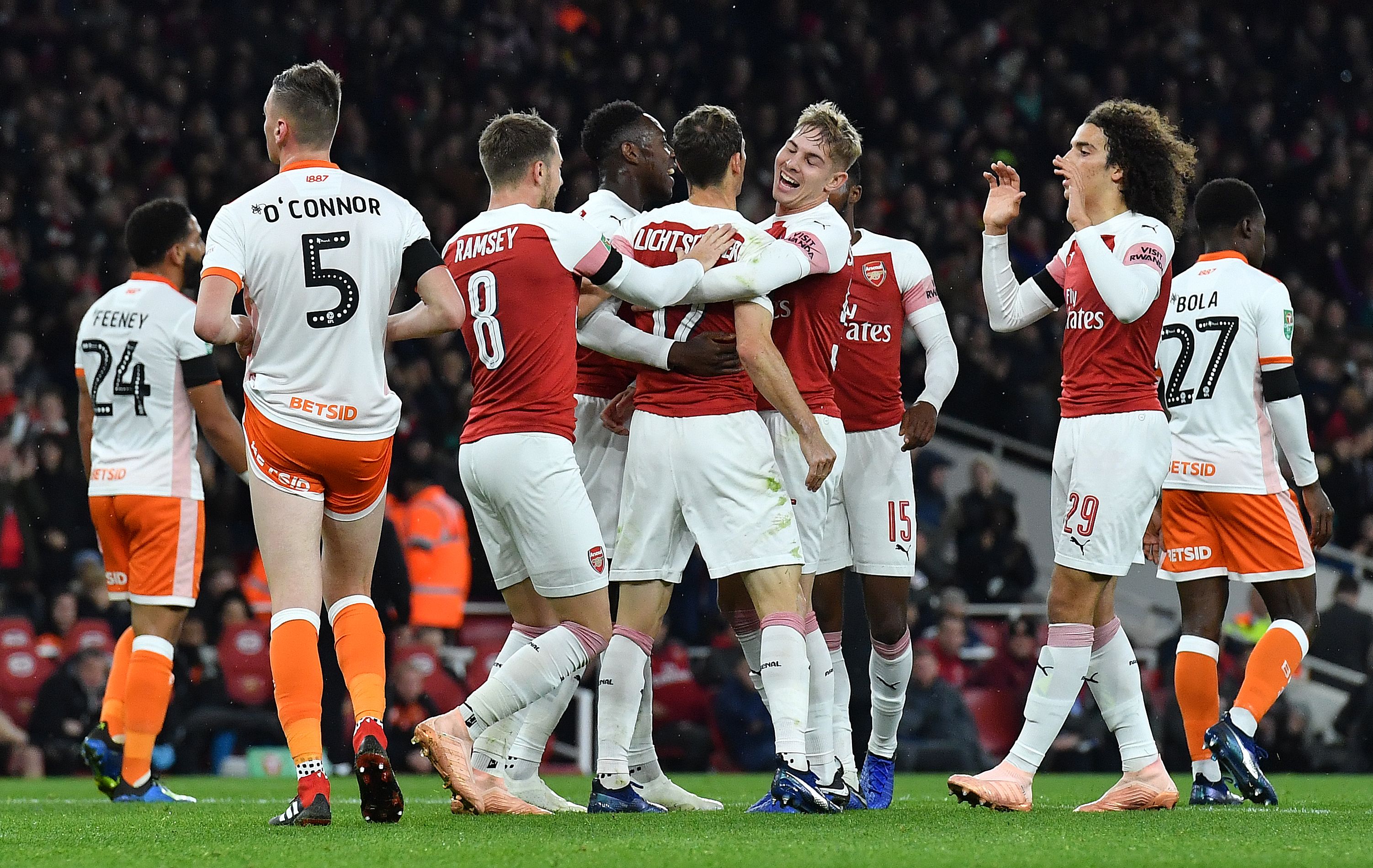 Arsenal's Swiss defender Stephan Lichtsteiner (C) celebrates scoring the opening goal with teammates during the English League Cup football match between West Ham United and Tottenham Hotspur at The London Stadium, in east London on October 31, 2018. (Photo by Ben STANSALL / AFP) / RESTRICTED TO EDITORIAL USE. No use with unauthorized audio, video, data, fixture lists, club/league logos or 'live' services. Online in-match use limited to 120 images. An additional 40 images may be used in extra time. No video emulation. Social media in-match use limited to 120 images. An additional 40 images may be used in extra time. No use in betting publications, games or single club/league/player publications. /         (Photo credit should read BEN STANSALL/AFP/Getty Images)