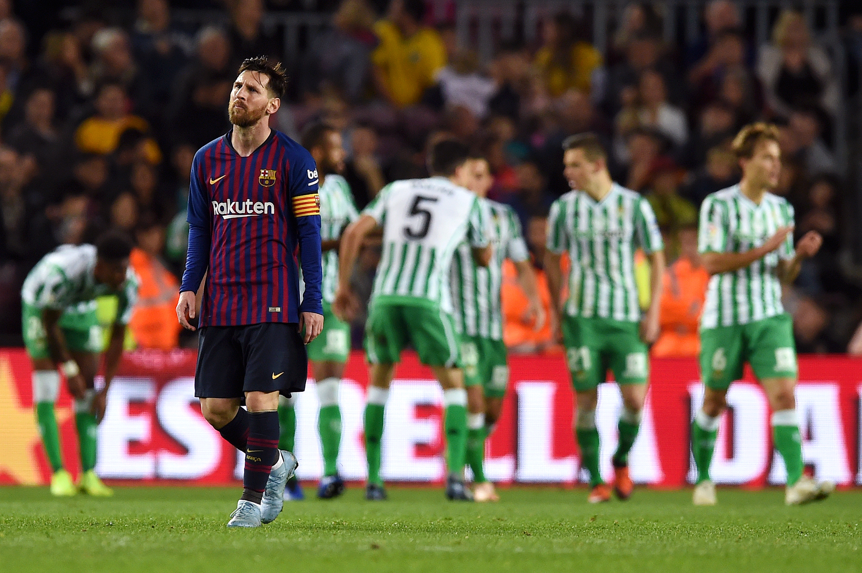 BARCELONA, SPAIN - NOVEMBER 11: Lionel Messi of Barcelona looks dejected as the Real Betis players celebrate their sides fourth goal during the La Liga match between FC Barcelona and Real Betis Balompie at Camp Nou on November 11, 2018 in Barcelona, Spain. (Photo by Alex Caparros/Getty Images)
