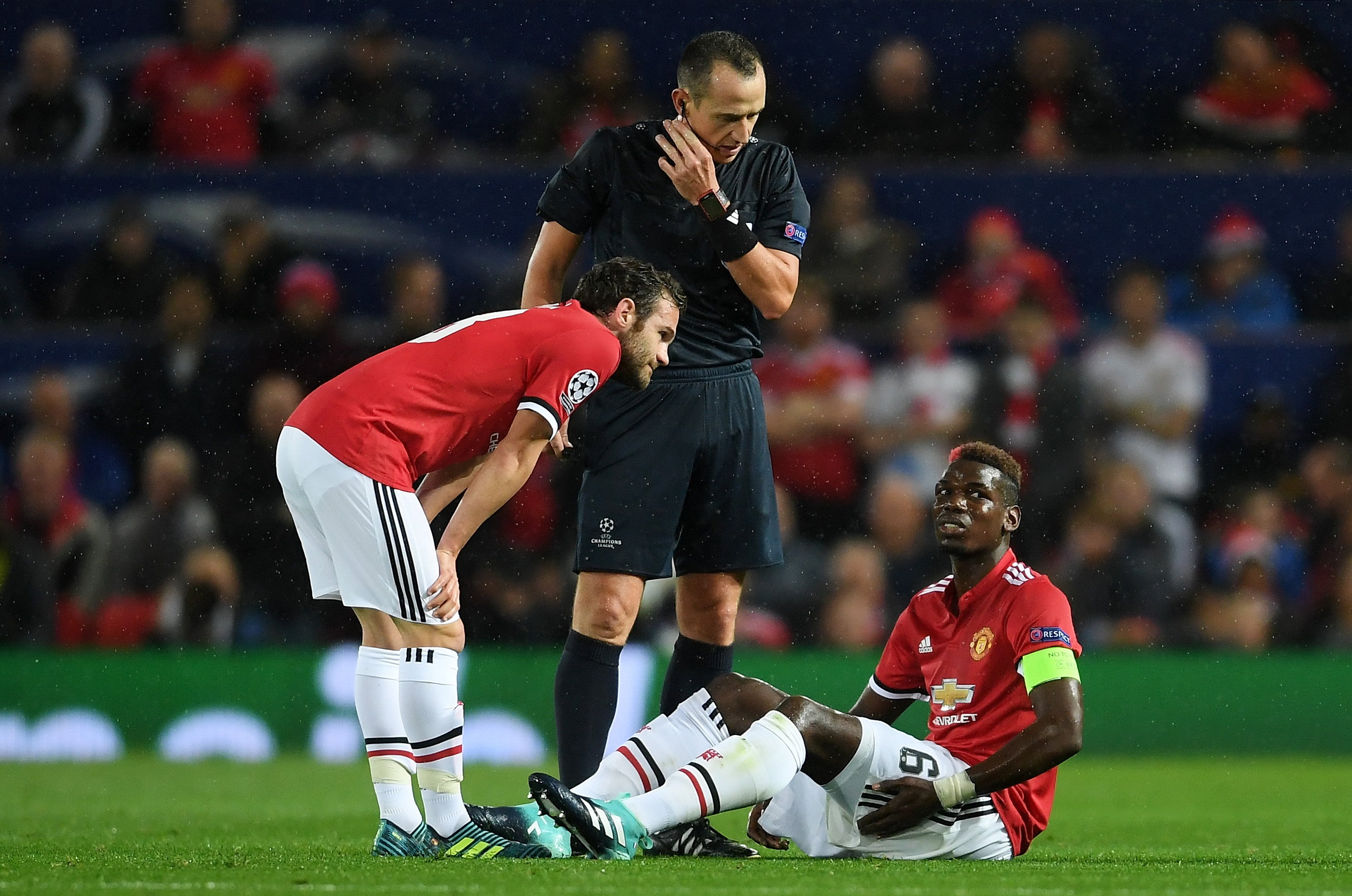 MANCHESTER, ENGLAND - SEPTEMBER 12: Juan Mata of Manchester United checks if Paul Pogba of Manchestr United is okay after he goes down injured during the UEFA Champions League Group A match between Manchester United and FC Basel at Old Trafford on September 12, 2017 in Manchester, United Kingdom. (Photo by Laurence Griffiths/Getty Images)