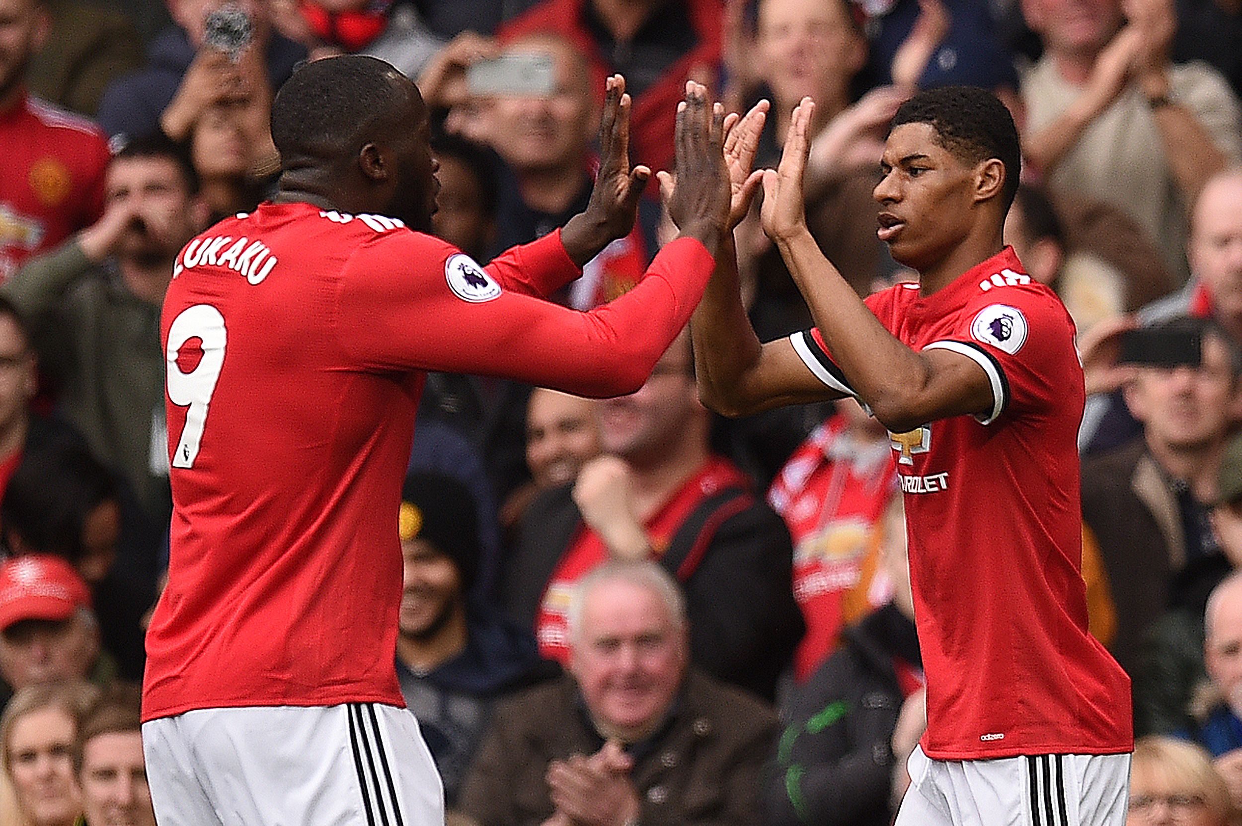 Manchester United's English striker Marcus Rashford (R) celebrates scoring the opening goal with Manchester United's Belgian striker Romelu Lukaku (L) during the English Premier League football match between Manchester United and Liverpool at Old Trafford in Manchester, north west England, on March 10, 2018. / AFP PHOTO / Oli SCARFF / RESTRICTED TO EDITORIAL USE. No use with unauthorized audio, video, data, fixture lists, club/league logos or 'live' services. Online in-match use limited to 75 images, no video emulation. No use in betting, games or single club/league/player publications. / (Photo credit should read OLI SCARFF/AFP/Getty Images)