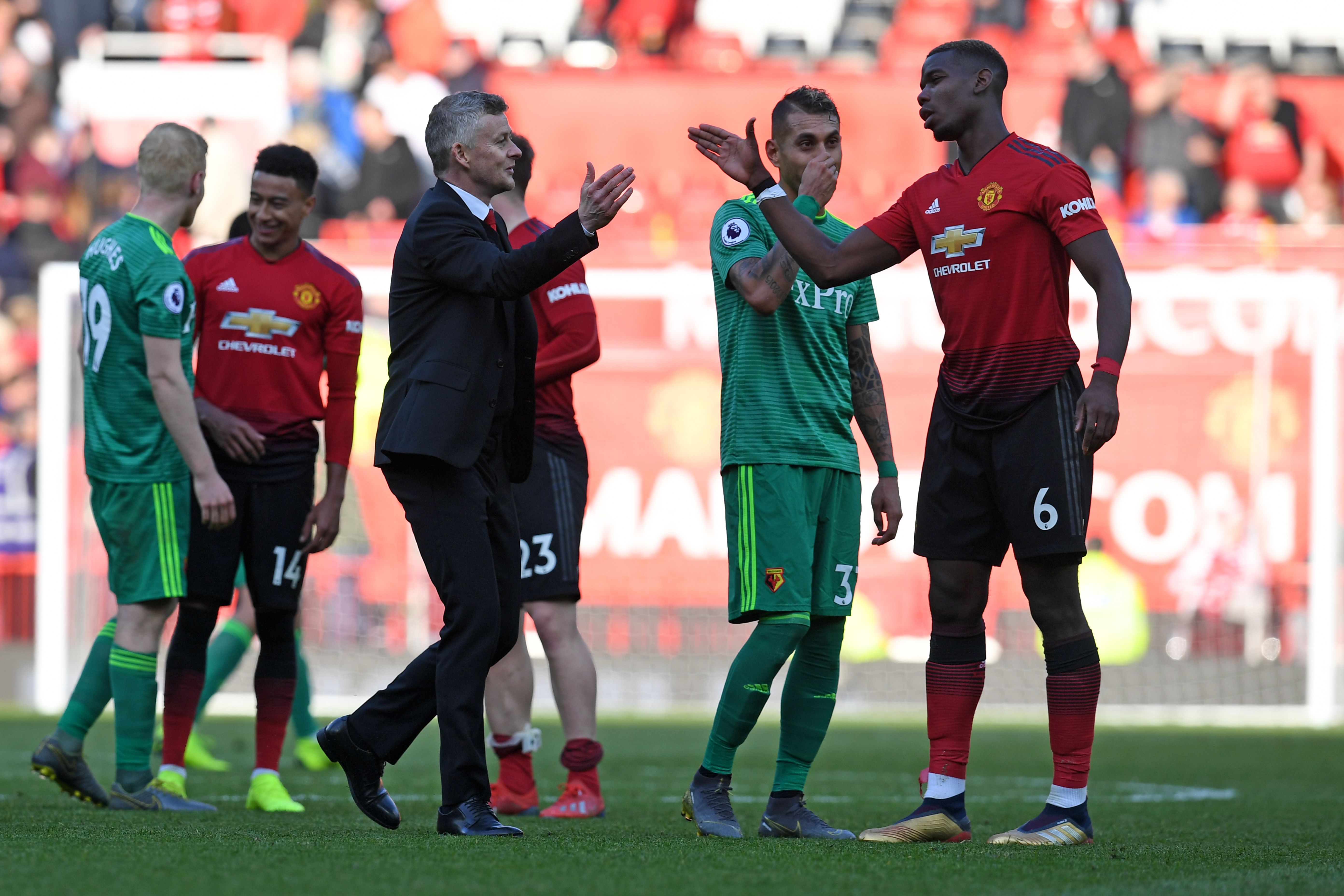 Manchester United's Norwegian manager Ole Gunnar Solskjaer (L) shakes hands with Manchester United's French midfielder Paul Pogba (R) after the final whistle of the English Premier League football match between Manchester United and Watford at Old Trafford in Manchester, north west England, on March 30, 2019. (Photo by Paul ELLIS / AFP) / RESTRICTED TO EDITORIAL USE. No use with unauthorized audio, video, data, fixture lists, club/league logos or 'live' services. Online in-match use limited to 120 images. An additional 40 images may be used in extra time. No video emulation. Social media in-match use limited to 120 images. An additional 40 images may be used in extra time. No use in betting publications, games or single club/league/player publications. / (Photo credit should read PAUL ELLIS/AFP/Getty Images)